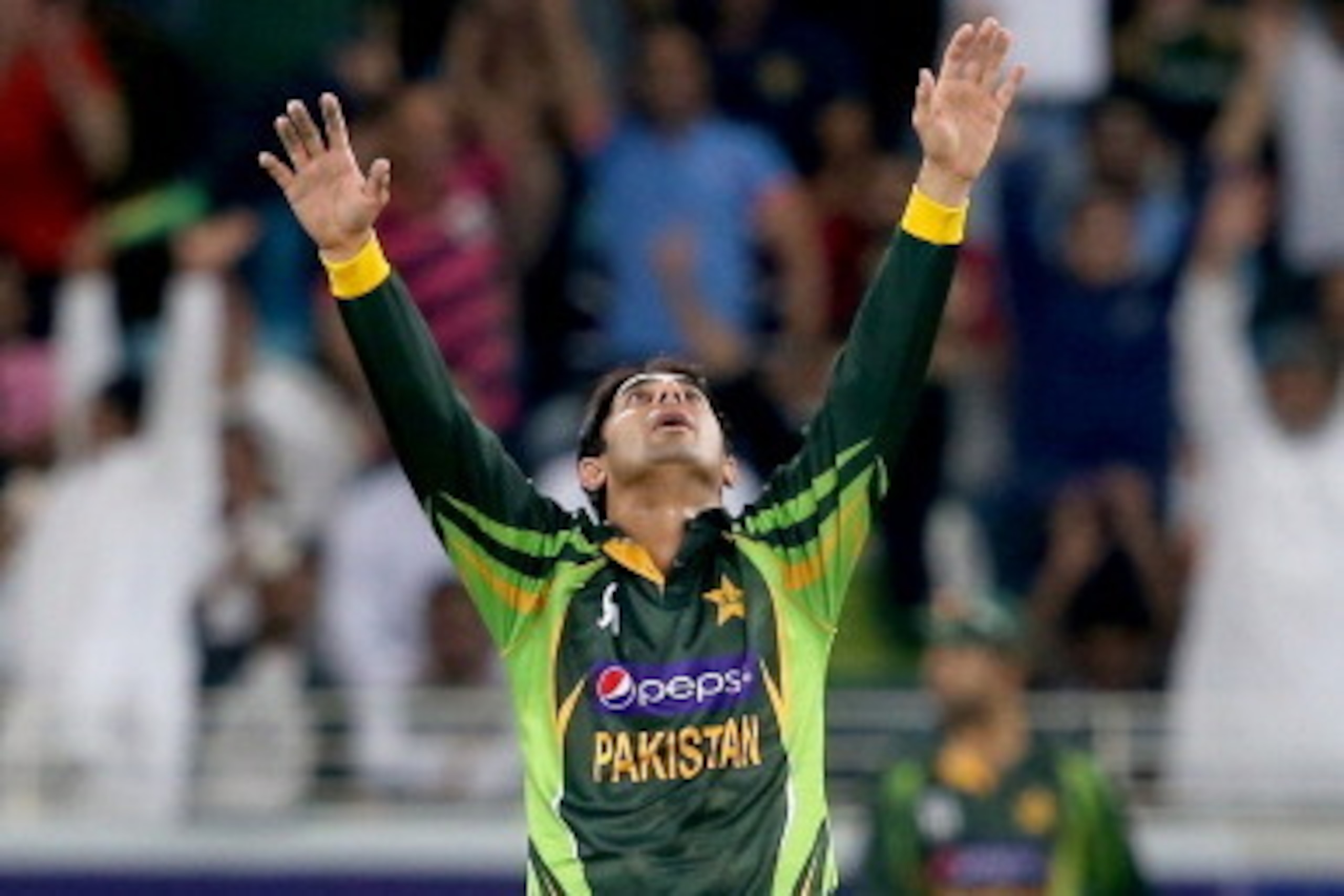 DUBAI, UNITED ARAB EMIRATES - DECEMBER 13:  Saeed Ajmal of Pakistan celebrates during the second Twenty20 International match between Pakistan and Sri Lanka at Dubai Sports City Cricket Stadium on December 13, 2013 in Dubai, United Arab Emirates.  (Photo 