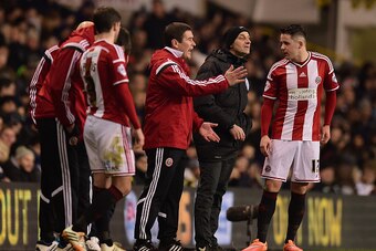 LONDON, ENGLAND - JANUARY 21:  Nigel Clough, manager of Sheffield United speaks to Marc McNulty of Sheffield United (R) during the Capital One Cup Semi-Final first leg match between Tottenham Hotspur and Sheffield United at White Hart Lane on January 21, 