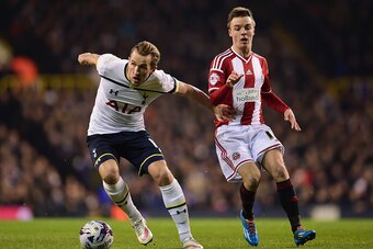 LONDON, ENGLAND - JANUARY 21:  Harry Kane of Spurs holds off Stefan Scougall of Sheffield United during the Capital One Cup Semi-Final first leg match between Tottenham Hotspur and Sheffield United at White Hart Lane on January 21, 2015 in London, England
