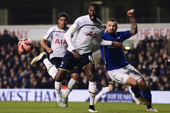 LONDON, ENGLAND - JANUARY 24: Emmanuel Adebayor of Tottenham Hotspur is challenged by Marcin Wasilewski of Leicester City during the FA Cup Fourth Round match between Tottenham Hotspur and Leicester City at White Hart Lane on January 24, 2015 in London, E