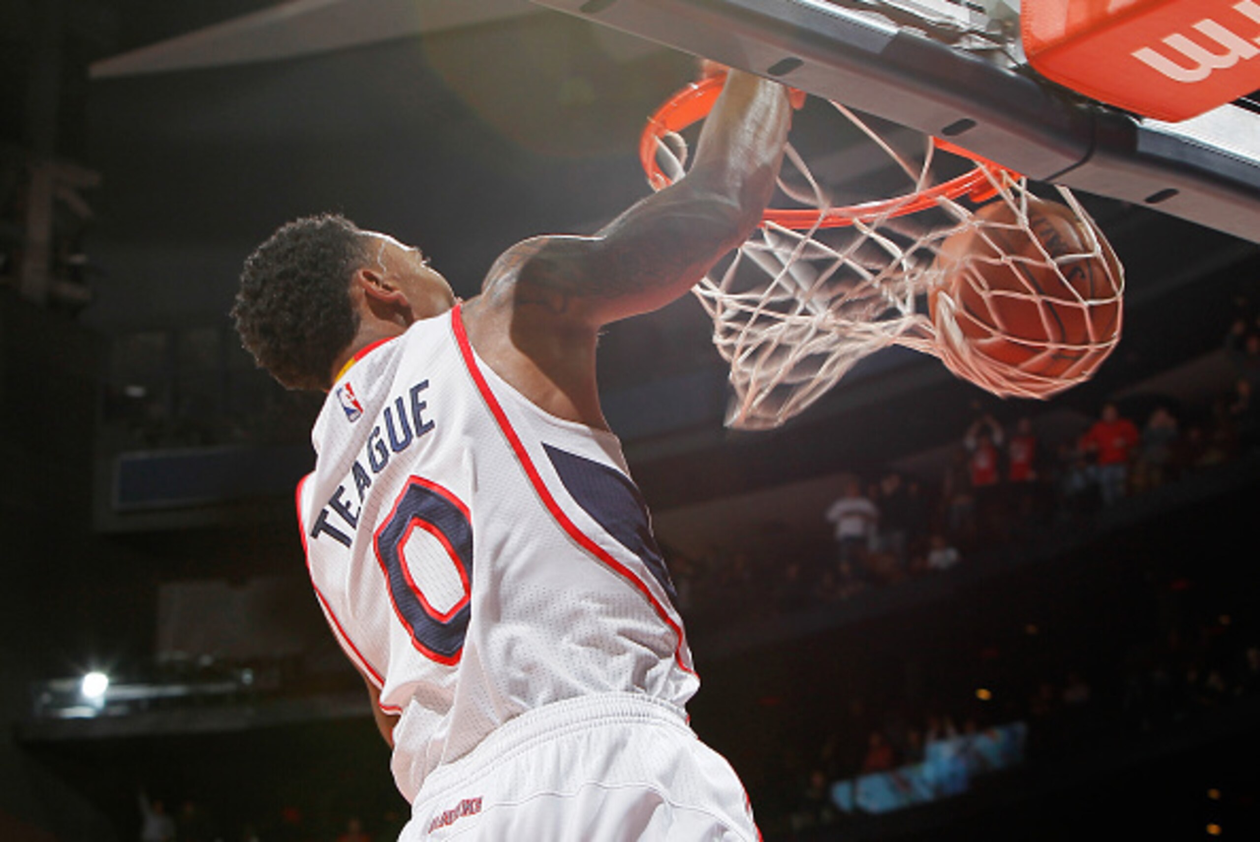 ATLANTA, GA - JANUARY 23:  Jeff Teague #0 of the Atlanta Hawks dunks after a steal against the Oklahoma City Thunder at Philips Arena on January 23, 2015 in Atlanta, Georgia.  NOTE TO USER: User expressly acknowledges and agrees that, by downloading and o