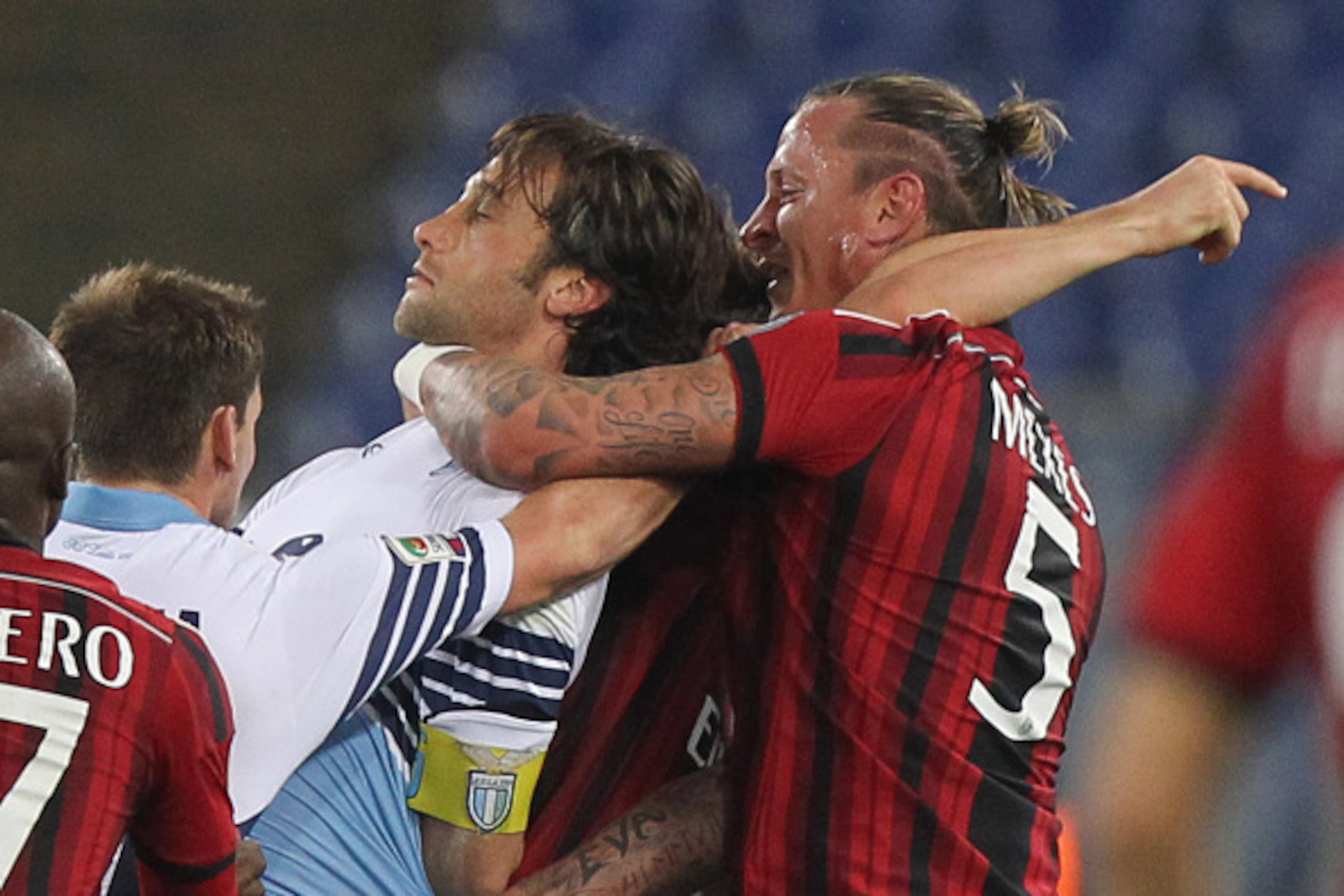 ROME, ITALY - JANUARY 24:  Philippe Mexes #5 of AC Milan and Stefano Mauri of SS Lazio react during the Serie A match between SS Lazio and AC Milan at Stadio Olimpico on January 24, 2015 in Rome, Italy.  (Photo by Paolo Bruno/Getty Images)
