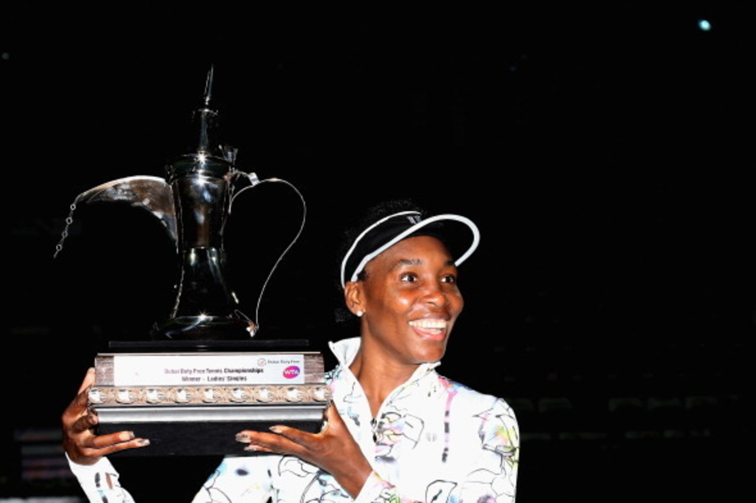 DUBAI, UNITED ARAB EMIRATES - FEBRUARY 22:  Venus Williams of the USA poses with the trophy after beating Alize Cornet of France in the final of the WTA Dubai Dury Free Tennis Championship at the Dubai Tennis Stadium on February 22, 2014 in Dubai, United 
