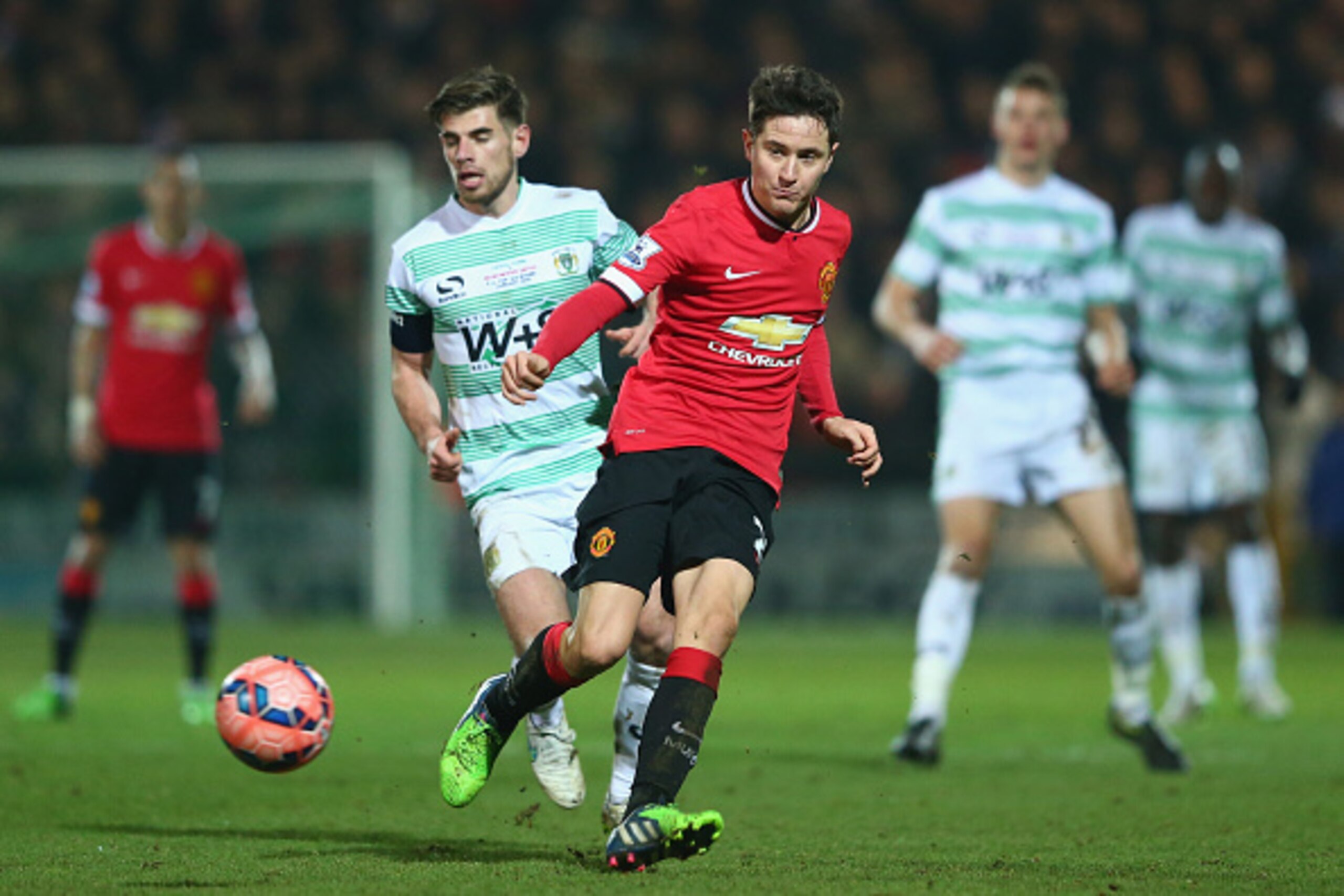YEOVIL, ENGLAND - JANUARY 04:  Ander Herrera of Manchester United is tracked by Joseph Edwards of Yeovil Town during the FA Cup Third Round match between Yeovil Town and Manchester United at Huish Park on January 4, 2015 in Yeovil, England.  (Photo by Mic