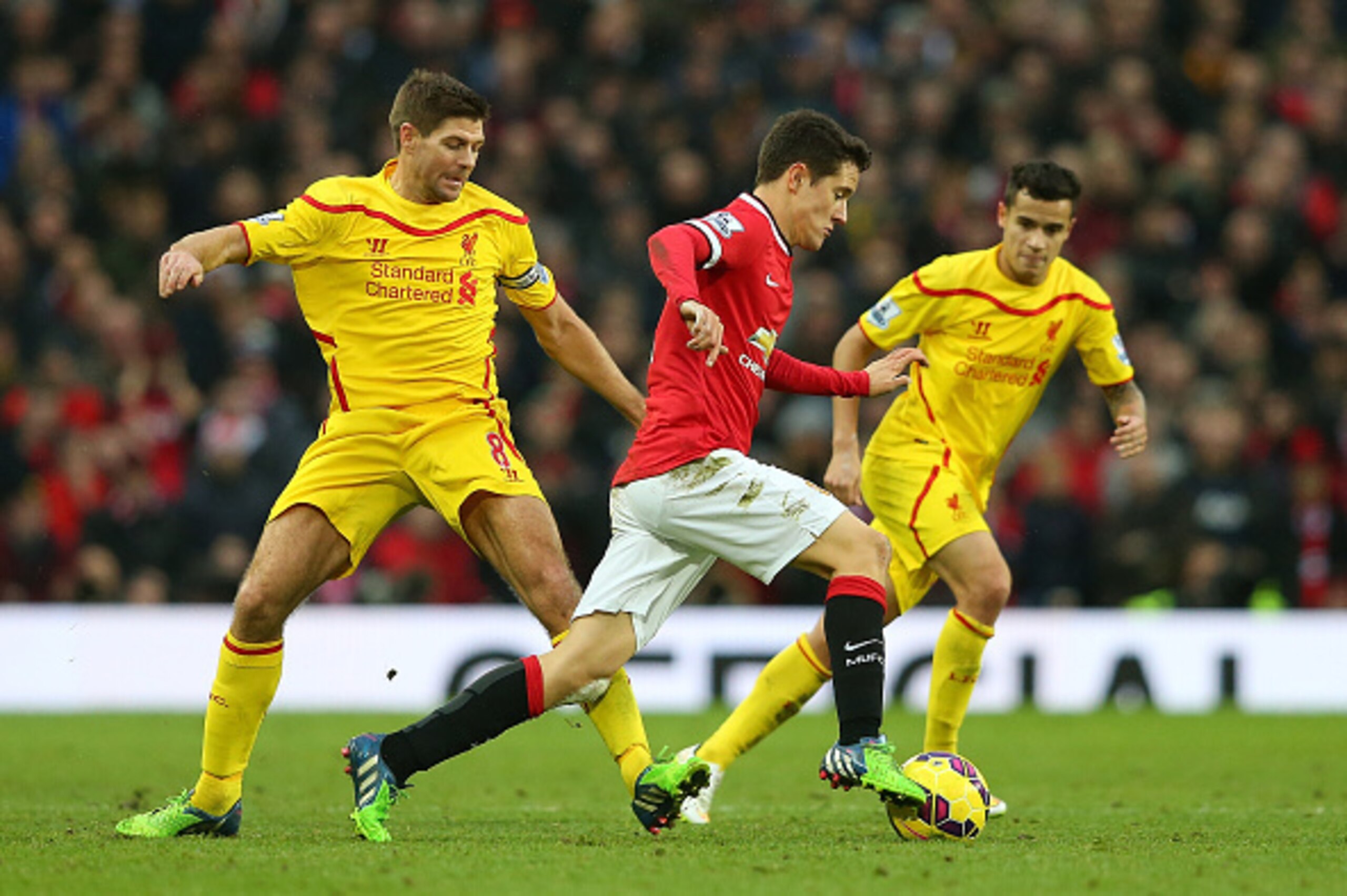 MANCHESTER, ENGLAND - DECEMBER 14:  Steven Gerrard of Liverpool competes with Ander Herrera of Manchester United during the Barclays Premier League match between Manchester United and Liverpool at Old Trafford on December 14, 2014 in Manchester, England. 