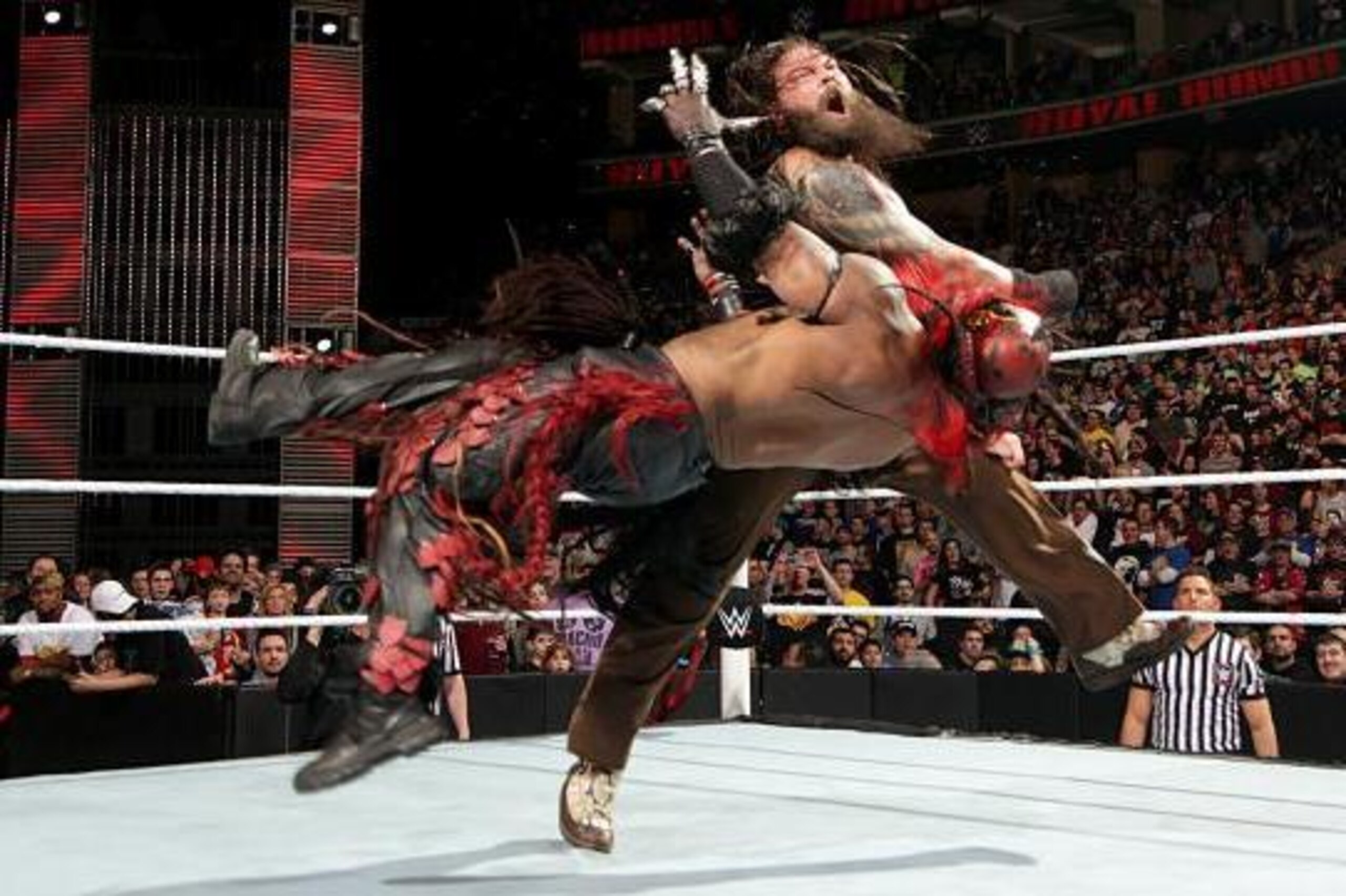 Bray Wyatt clobbers Boogeyman with a clothesline.