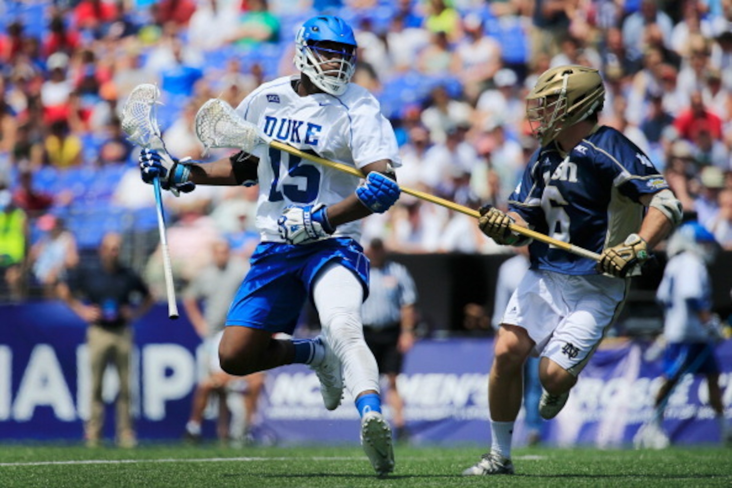 BALTIMORE, MD - MAY 26: Myles Jones #15 of the Duke Blue Devils works the ball around Chris Prevoznik #6 of the Notre Dame Fighting Irish during the first half of the 2014 NCAA Division I Men's Lacrosse Championship at M&T Bank Stadium on May 26, 2014 in 