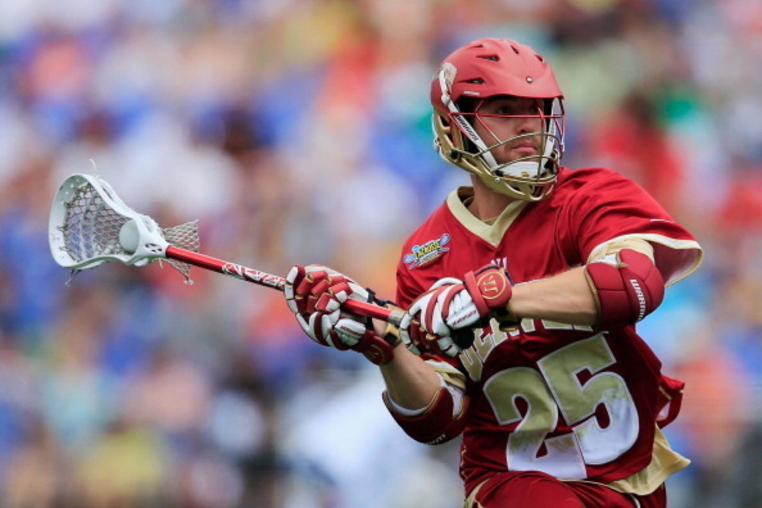 BALTIMORE, MD - MAY 24: Garret Holst #25 of the Denver Pioneers passes the ball against the Duke Blue Devils during the semifinals of the 2014 NCAA Division I Men's Lacrosse Championship at M&T Bank Stadium on May 24, 2014 in Baltimore, Maryland.  (Photo 