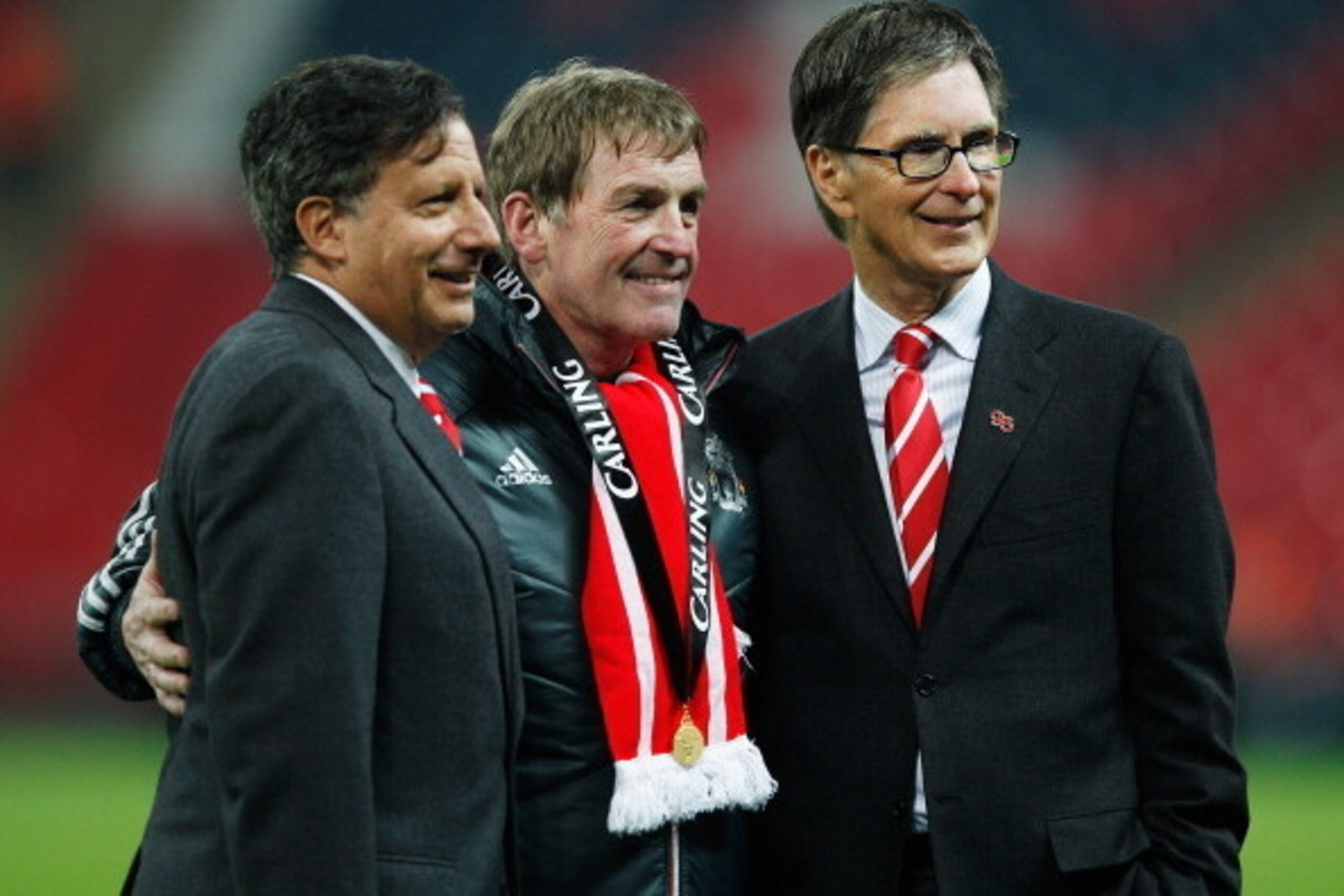 LONDON, ENGLAND - FEBRUARY 26:  Kenny Dalglish manager of Liverpool celebrates with Liverpool owners Liverpool owner Tom Werner (L) and John W Henry (R) after victory in the Carling Cup Final match between Liverpool and Cardiff City at Wembley Stadium on 