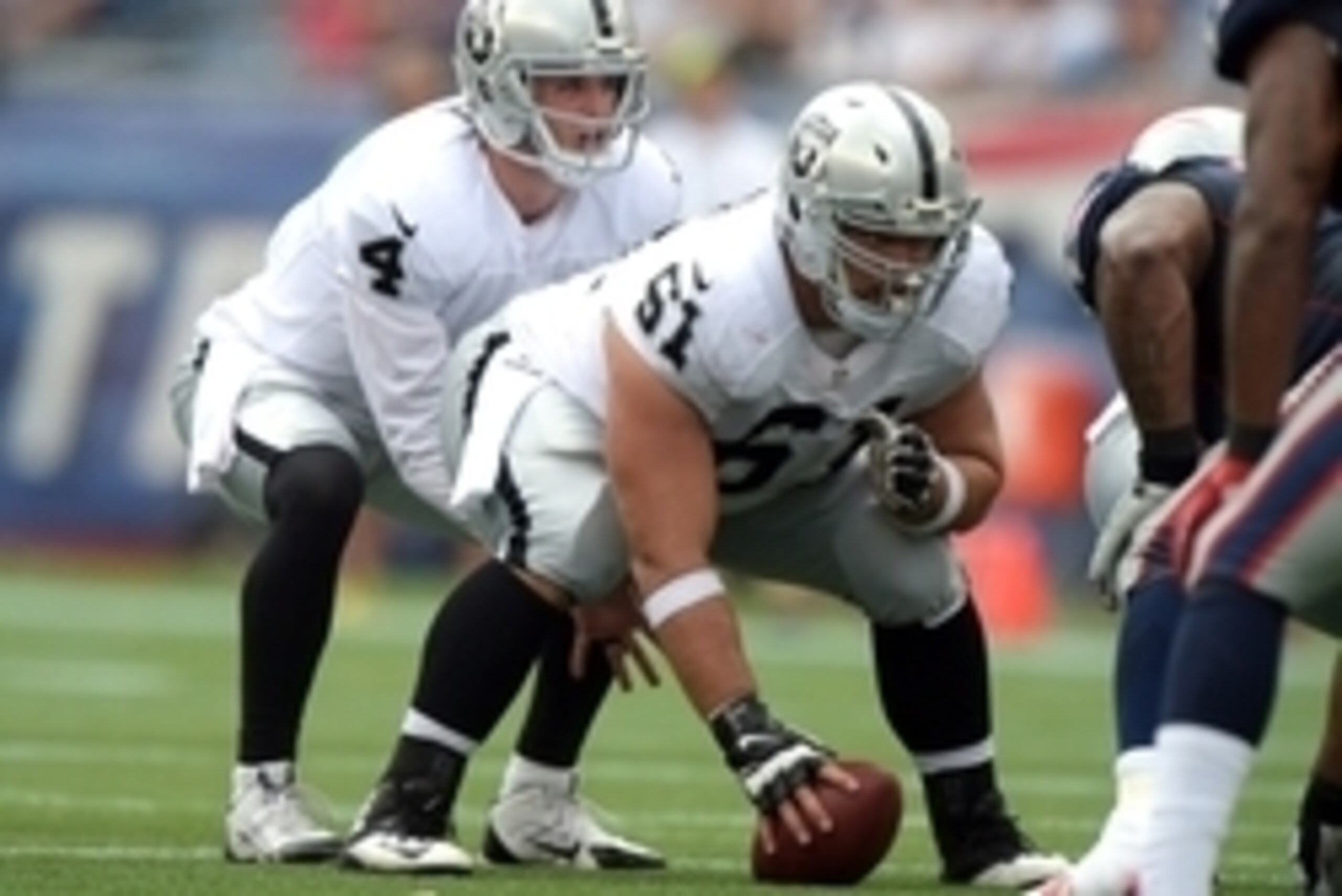 Sep 21, 2014; Foxborough, MA, USA; Oakland Raiders quarterback Derek Carr (4) takes the snap from center Stefen Wisniewski (61) against the New England Patriots at Gillette Stadium. Mandatory Credit: Kirby Lee-USA TODAY Sports