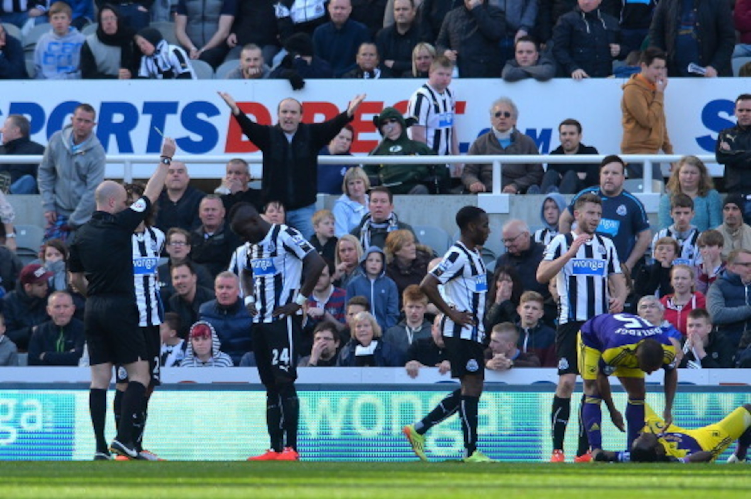 NEWCASTLE UPON TYNE, ENGLAND - APRIL 19: Cheik Tiote of Newcastle United receives a yellow card after giving away a late Swansea City penalty during the Barclays Premier League match between Newcastle United and Swansea City at St James Park on April 19, 