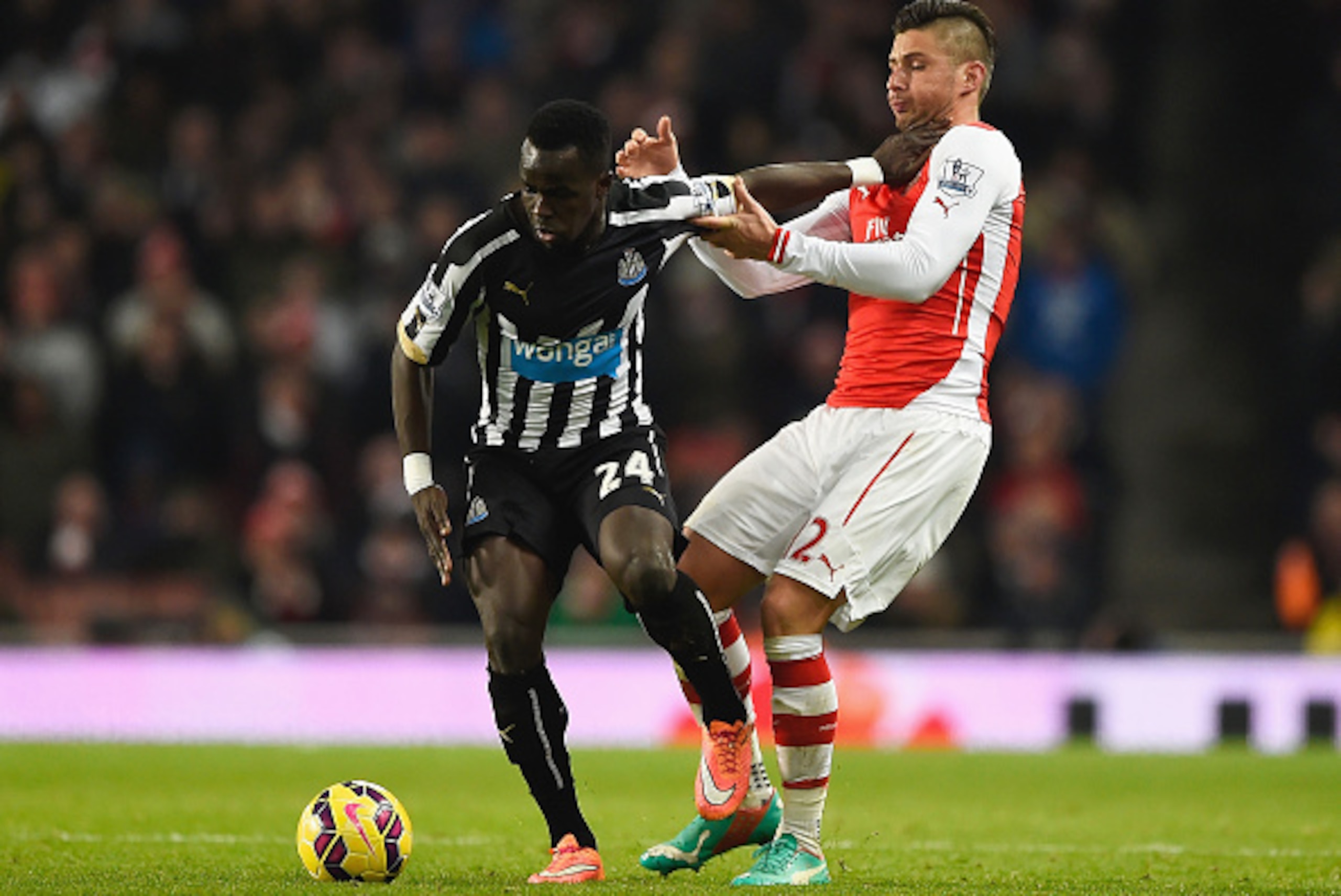 LONDON, ENGLAND - DECEMBER 13: Cheik Ismael Tiote of Newcastle United is challenged by Olivier Giroud of Arsenal during the Barclays Premier League match between Arsenal and Newcastle United at Emirates Stadium on December 13, 2014 in London, England.  (P