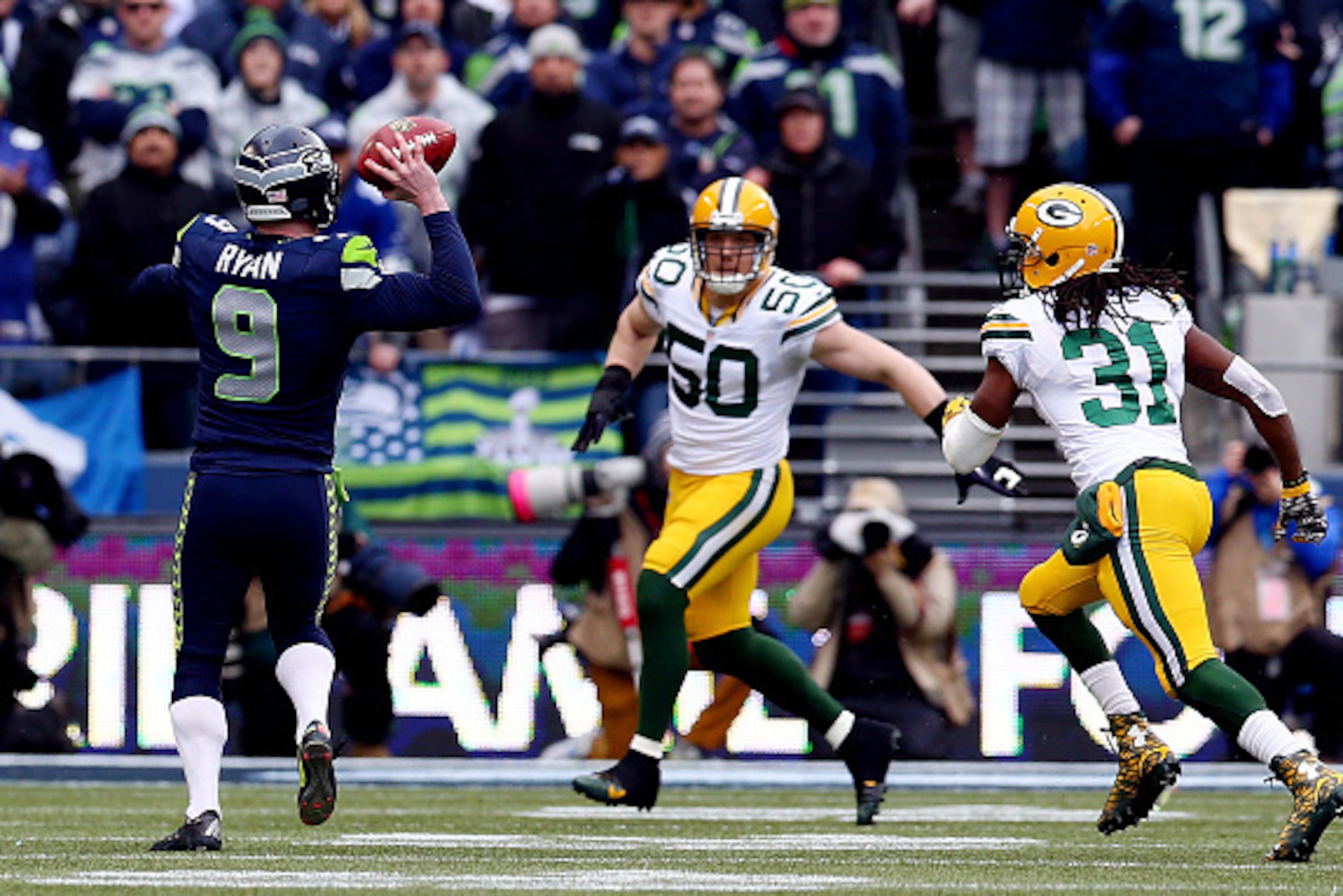 SEATTLE, WA - JANUARY 18:  Holder Jon Ryan #9 of the Seattle Seahawks throws a 19 yard touchdown pass to Garry Gilliam #79 in the second half against the Green Bay Packers during the 2015 NFC Championship game at CenturyLink Field on January 18, 2015 in S