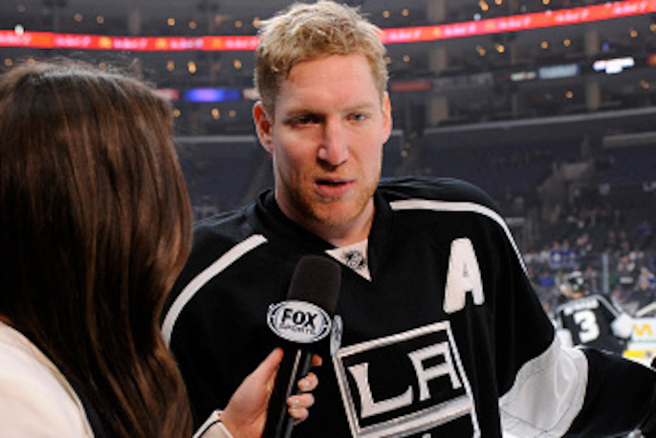 LOS ANGELES, CA - JANUARY 12: Matt Greene #2 of the Los Angeles Kings speaks with Alex Curry of Fox Sports West before the game against the Maple Leafs at STAPLES Center on January 12, 2015 in Los Angeles, California. (Photo by Juan Ocampo/NHLI via Getty 