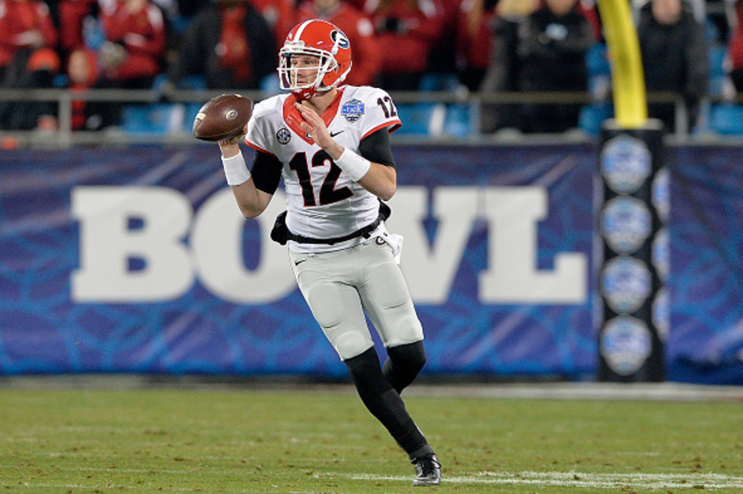 CHARLOTTE, NC - DECEMBER 30:  Brice Ramsey #12 of the Georgia Bulldogs rolls out against the Louisville Cardinals during the Belk Bowl at Bank of America Stadium on December 30, 2014 in Charlotte, North Carolina. Georgia won 37-14.  (Photo by Grant Halver