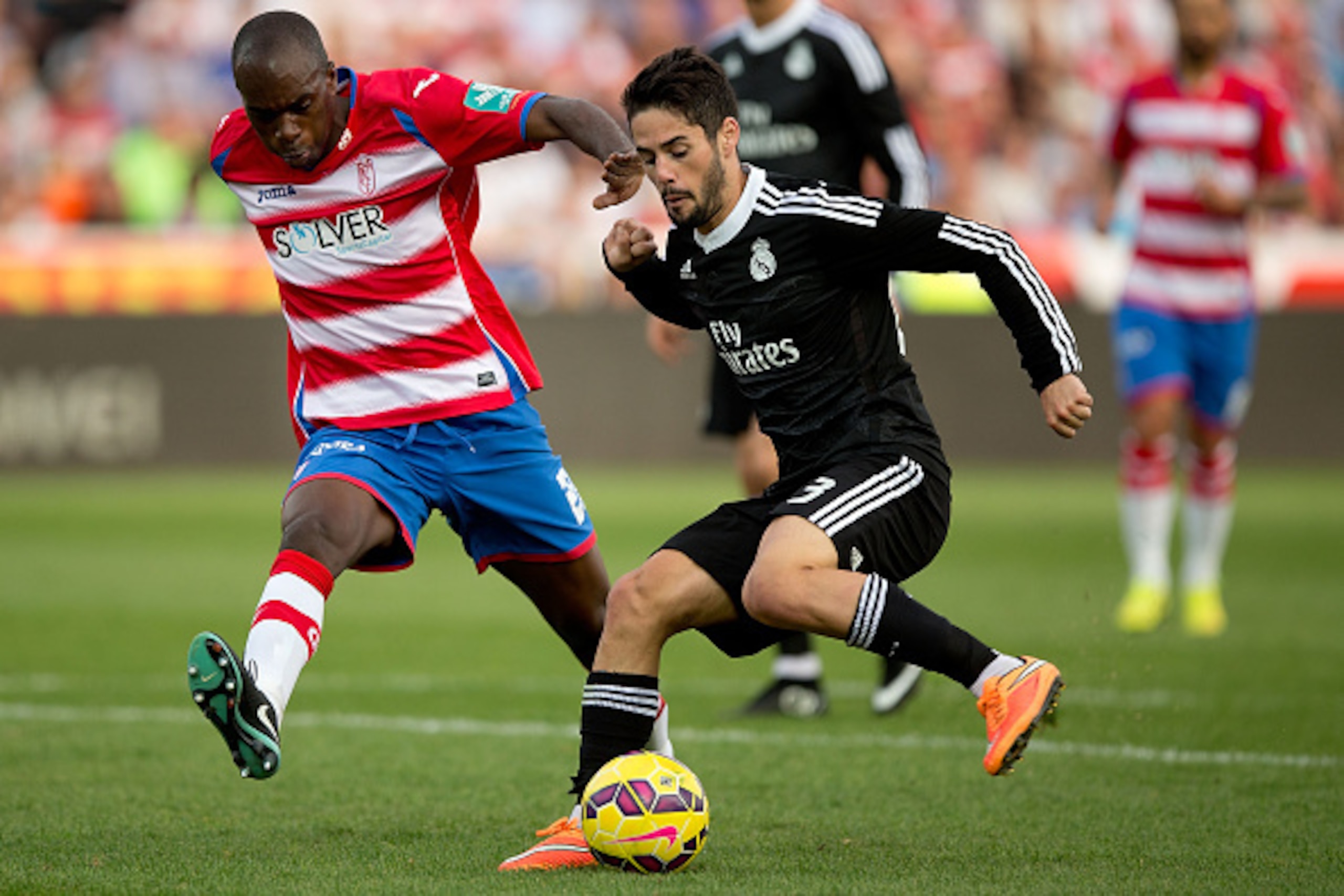 GRANADA, SPAIN - NOVEMBER 01: Francisco Roman Alarcon (Isco) (R) of Real Madrid CF competes for the ball with Allan Nyom (L) of Granada CF during the La Liga match between Granada CF and Real Madrid CF at Nuevo Estadio de Los Carmenes on November 1, 2014 GRANADA, SPAIN - NOVEMBER 01: Francisco Roman Alarcon (Isco) (R) of Real Madrid CF competes for the ball with Allan Nyom (L) of Granada CF during the La Liga match between Granada CF and Real Madrid CF at Nuevo Estadio de Los Carmenes on November 1, 2014