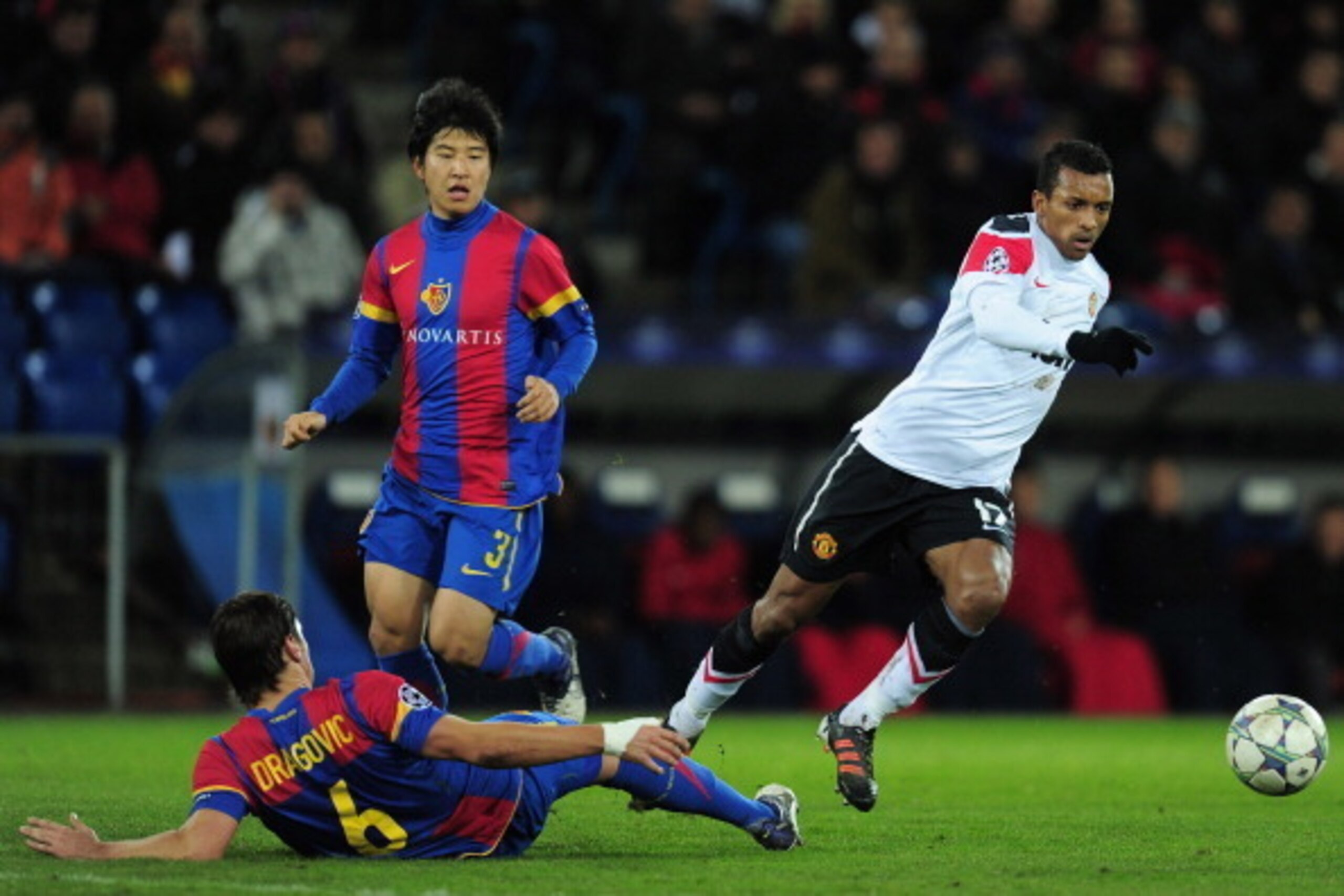 BASEL, SWITZERLAND - DECEMBER 07:  Aleksandar Dragovic of Basel tackles Nani of Manchester United during the UEFA Champions League Group C match between FC Basel 1893 and Manchester United at St. Jakob-Park on December 7, 2011 in Basel, Switzerland.  (Pho
