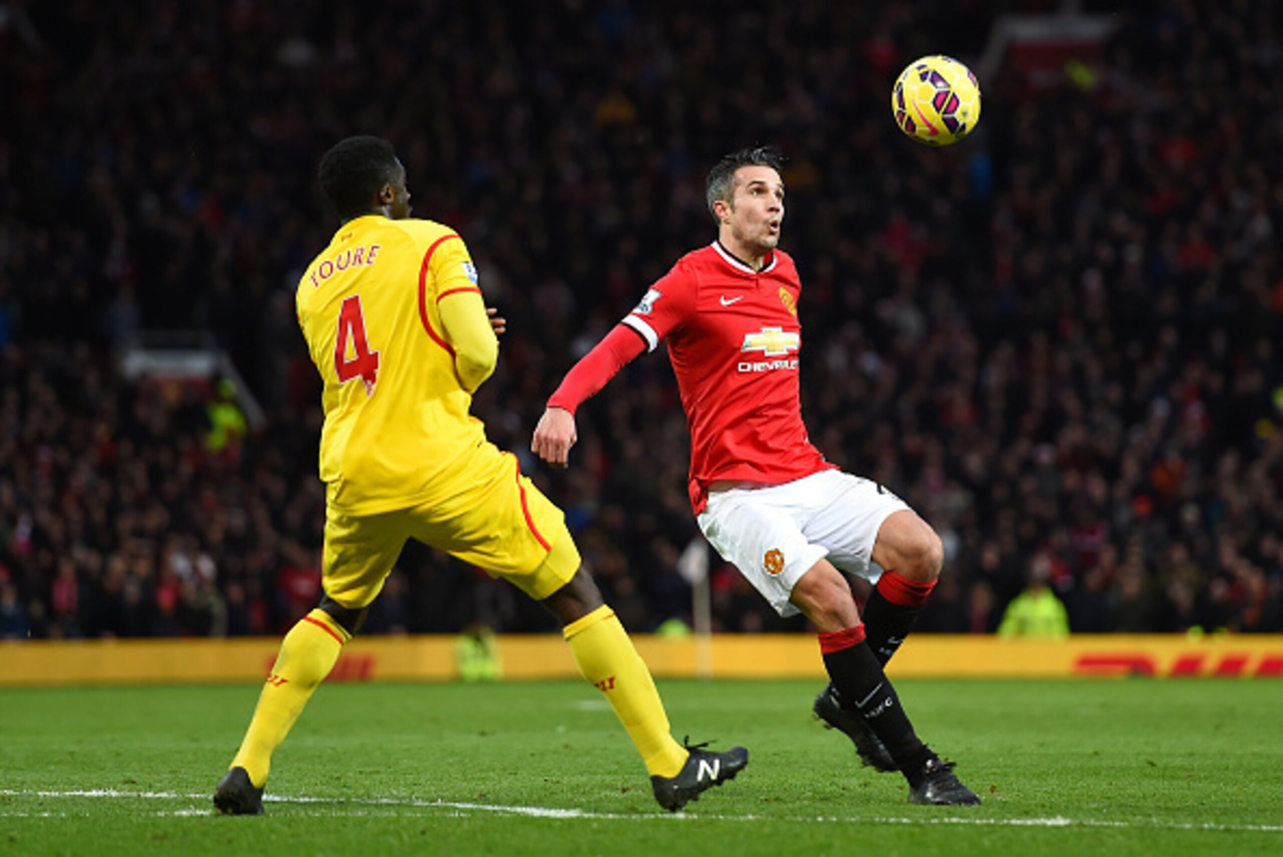 MANCHESTER, ENGLAND - DECEMBER 14:  Kolo Toure of Liverpool competes with Robin van Persie of Manchester United the Barclays Premier League match between Manchester United and Liverpool at Old Trafford on December 14, 2014 in Manchester, England.  (Photo 