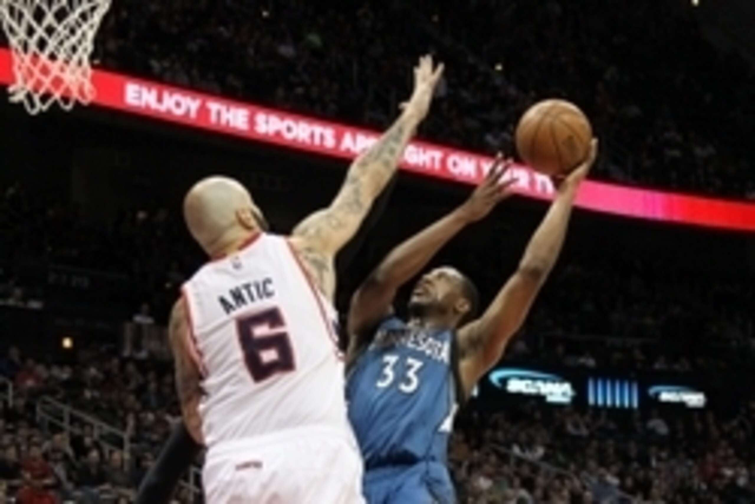 Jan 25, 2015; Atlanta, GA, USA; Minnesota Timberwolves forward Thaddeus Young (33) shoots the ball over Atlanta Hawks forward Pero Antic (6) in the first quarter at Philips Arena. Mandatory Credit: Brett Davis-USA TODAY Sports