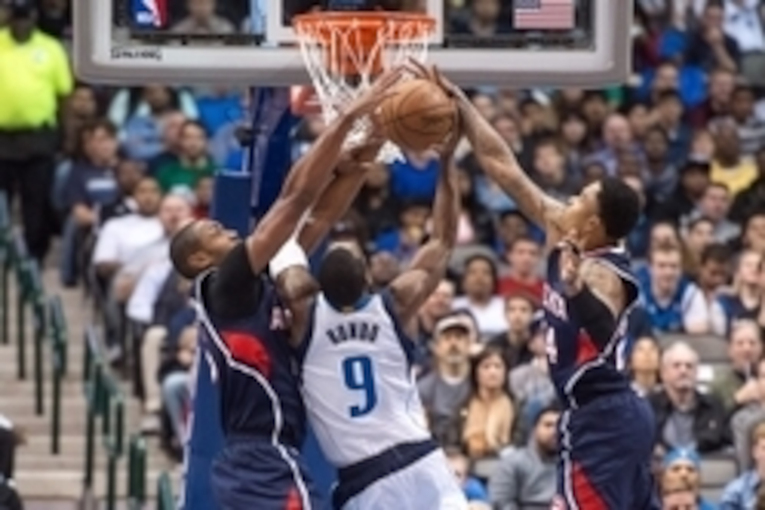 Dec 22, 2014; Dallas, TX, USA; Atlanta Hawks center Al Horford (15) and guard Kent Bazemore (24) block a shot by Dallas Mavericks guard Rajon Rondo (9) during the first half at the American Airlines Center. Mandatory Credit: Jerome Miron-USA TODAY Sports
