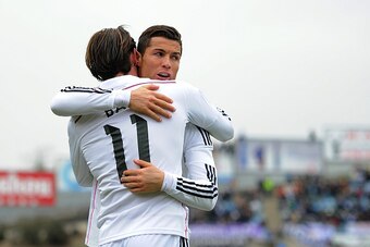 GETAFE, SPAIN - JANUARY 18:  Gareth Bale of Real Madrid celebrates with Cristiano Ronaldo after scoring his team's 2nd goal during the La Liga match between Getafe CF and Real Madrid CF at Coliseum Alfonso Perez stadium on January 18, 2015 in Getafe, Spai