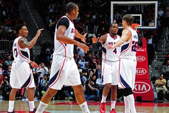 ATLANTA, GA - JANUARY 21:Jeff Teague #0, Al Horford #15, Paul Millsap #4, and Kyle Korver #26 of the Atlanta Hawks celebrate after a score against the Indiana Pacers on January 21, 2015 at Philips Arena in Atlanta, Georgia.  NOTE TO USER: User expressly a
