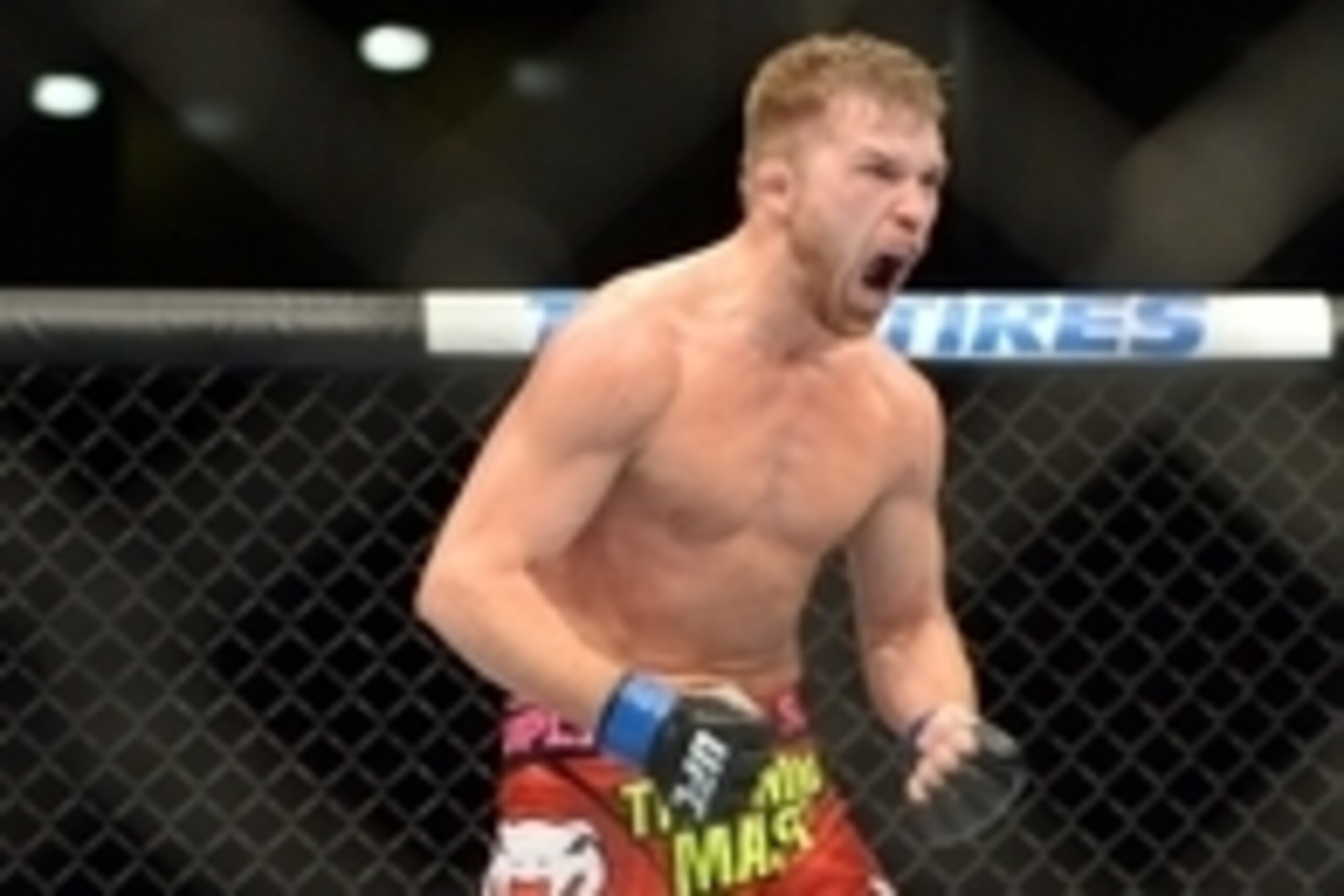 Jun 7, 2014; Albuquerque, NM, USA; Bryan Caraway (blue) celebrates his victory over Erik Perez their bantamweight bout during UFC Fight Night 42 at Tingley Coliseum. Caraway won via second round submission. Mandatory Credit: Joe Camporeale-USA TODAY Sport