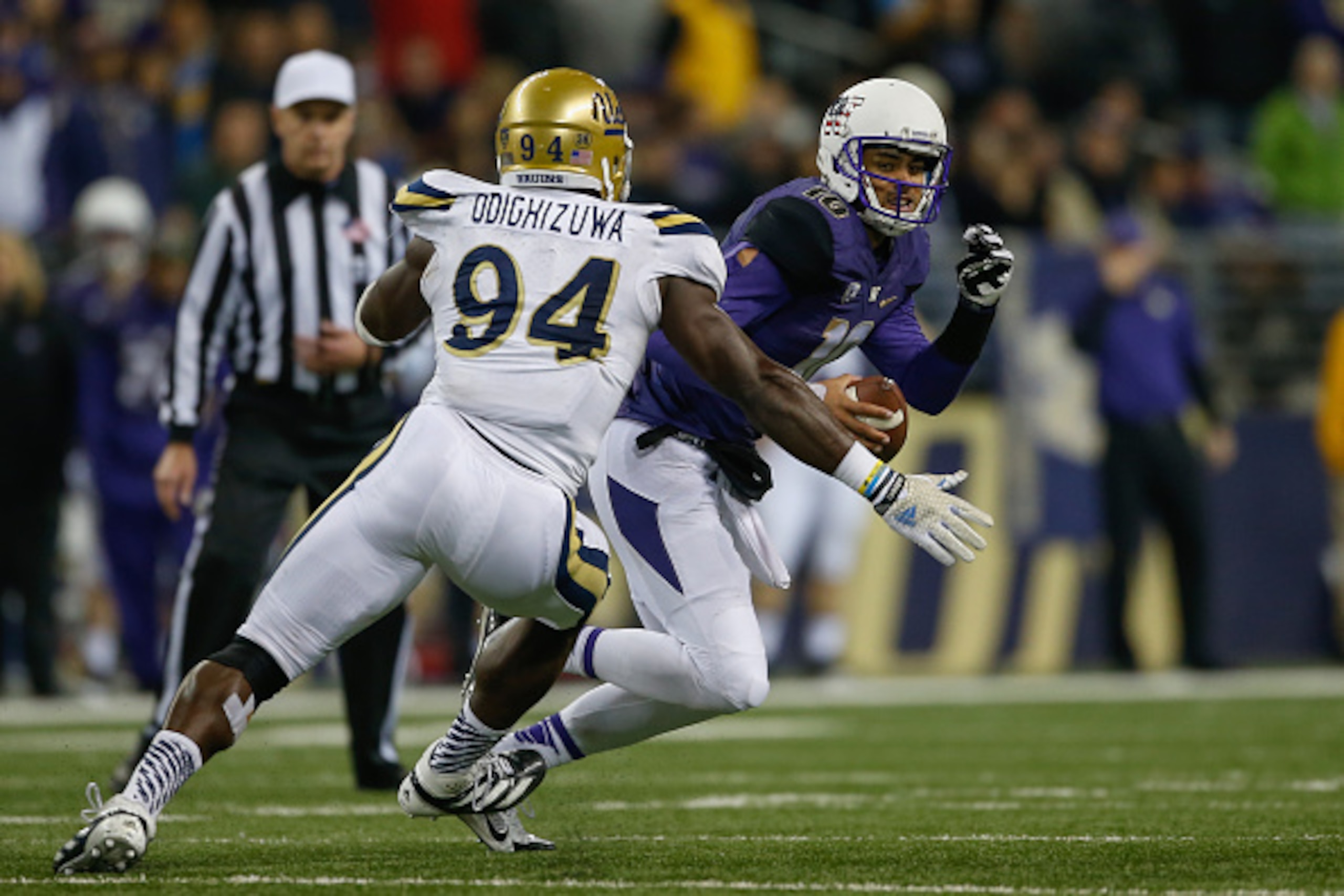 SEATTLE, WA - NOVEMBER 08:  Quarterback Cyler Miles #10 of the Washington Huskies rushes against Owamagbe Odighizuwa #94 of the UCLA Bruins on November 8, 2014 at Husky Stadium in Seattle, Washington.  (Photo by Otto Greule Jr/Getty Images)