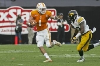 Jan 2, 2015; Jacksonville, FL, USA; Tennessee Volunteers running back Jalen Hurd (1) stiff arms Iowa Hawkeyes defensive back Jordan Lomax (27) in the first quarter of their 2015 TaxSlayer Bowl at EverBank Field. Mandatory Credit: Phil Sears-USA TODAY Spor