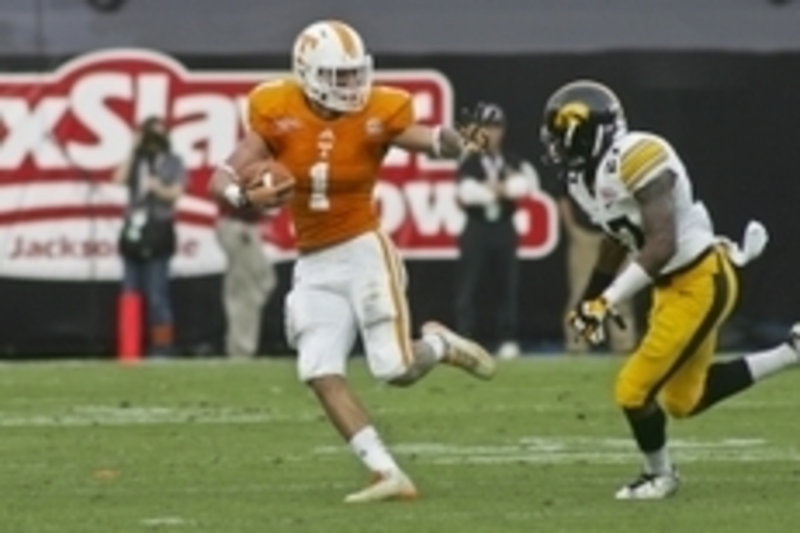 Jan 2, 2015; Jacksonville, FL, USA; Tennessee Volunteers running back Jalen Hurd (1) stiff arms Iowa Hawkeyes defensive back Jordan Lomax (27) in the first quarter of their 2015 TaxSlayer Bowl at EverBank Field. Mandatory Credit: Phil Sears-USA TODAY Spor