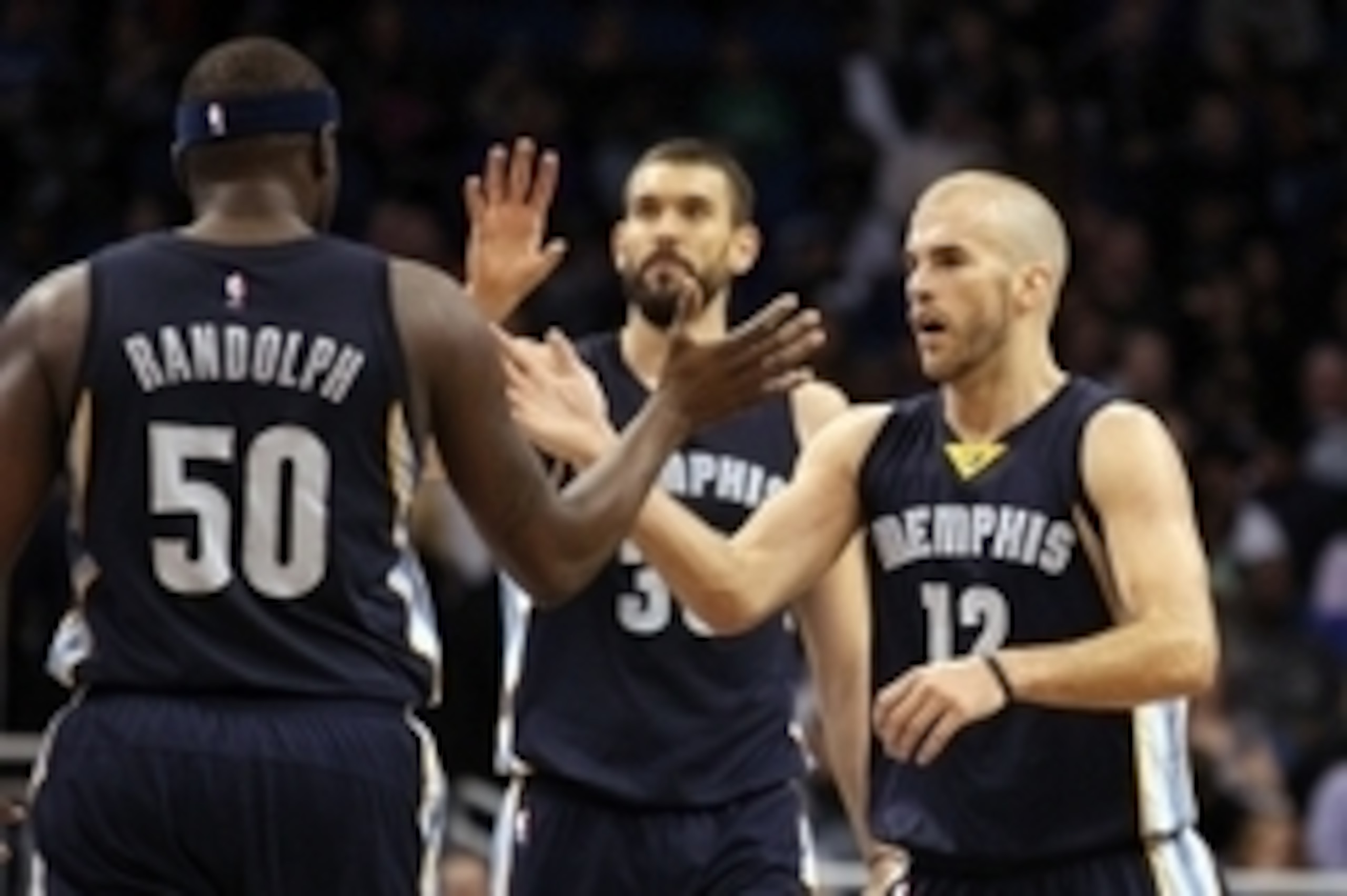 Jan 16, 2015; Orlando, FL, USA; Memphis Grizzlies guard Nick Calathes (12), forward Zach Randolph (50) and center Marc Gasol (33) high five against the Orlando Magic during the second half at Amway Center. Memphis Grizzlies defeated the Orlando Magic 106-