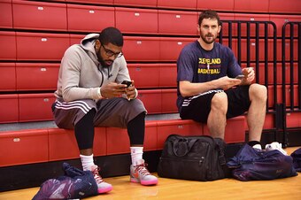 NEW YORK, NY- DECEMBER 7:  Kyrie Irving #2 and Kevin Love #0 of the Cleveland Cavaliers talk after practice on December 7, 2014 at Baruch College in New York, New York. NOTE TO USER: User expressly acknowledges and agrees that, by downloading and or using