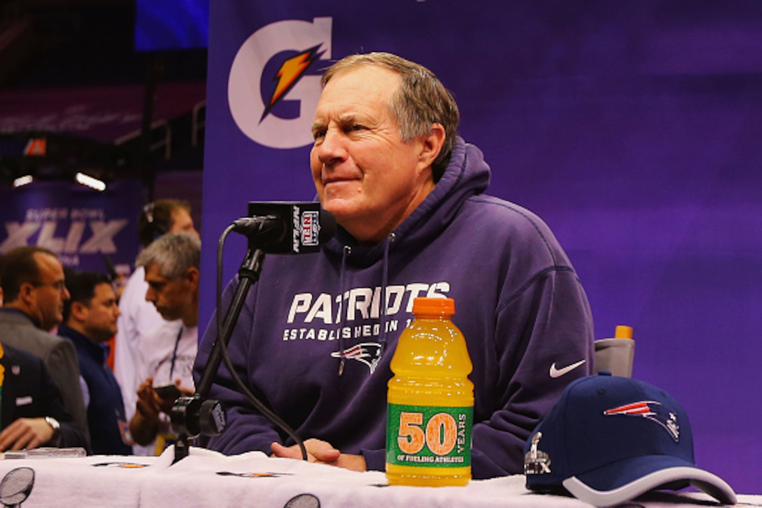 PHOENIX, AZ - JANUARY 27:  Head coach Bill Belichick of the New England Patriots addresses the media at Super Bowl XLIX Media Day Fueled by Gatorade inside U.S. Airways Center on January 27, 2015 in Phoenix, Arizona.  (Photo by Elsa/Getty Images)