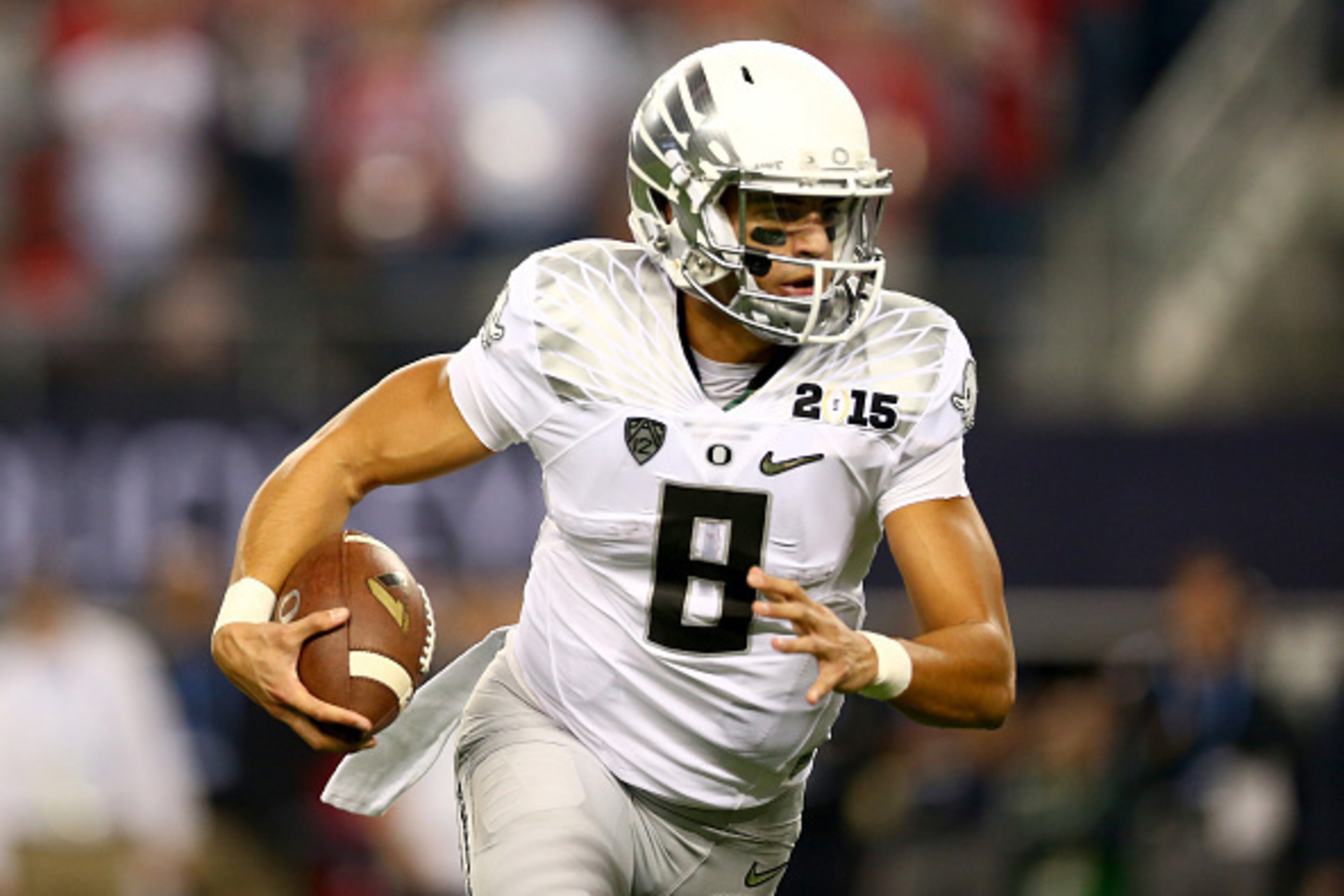 ARLINGTON, TX - JANUARY 12:  Quarterback Marcus Mariota #8 of the Oregon Ducks runs the ball against the Ohio State Buckeyes during the College Football Playoff National Championship Game at AT&T Stadium on January 12, 2015 in Arlington, Texas.  (Photo by