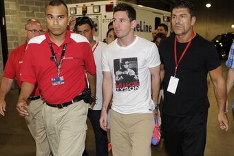 CHICAGO, IL - JULY 6:  Lionel Messi (C) of Messi & Friends enters the stadium for the Messi & Friends v The Rest of the World XI charity soccer match on July 6, 2013 at Soldier Field in Chicago, Illinois.   (Photo by David Banks/Getty Images for adidas)