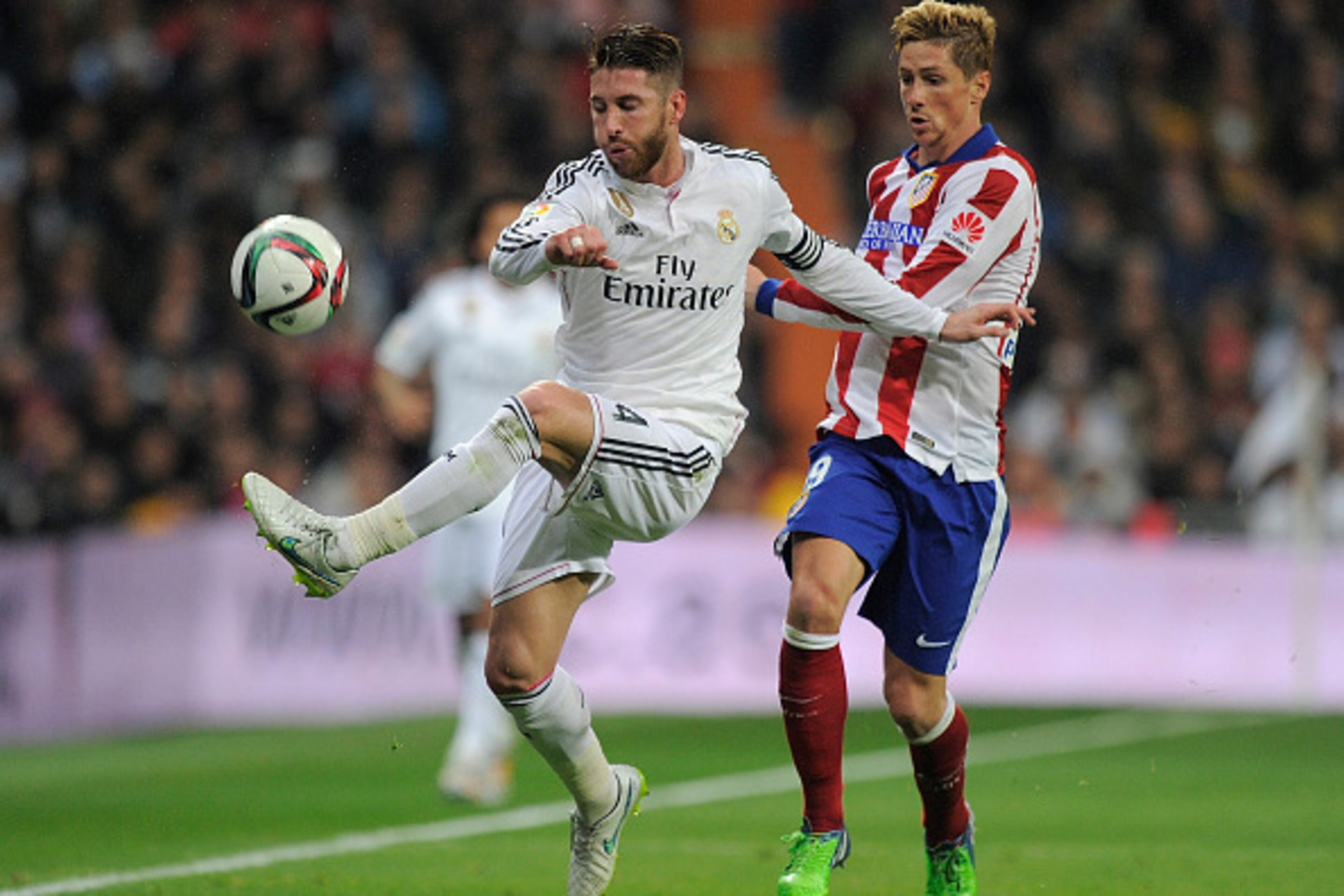 MADRID, SPAIN - JANUARY 15:  Fernando Torres of Atletico de Madrid in action against Sergio Ramos of Real Madrid
during the Copa del Rey Round of 16, Second leg match between Real Madrid and Atletico de Madrid at Estadio Santiago Bernabeu on January 15, 2