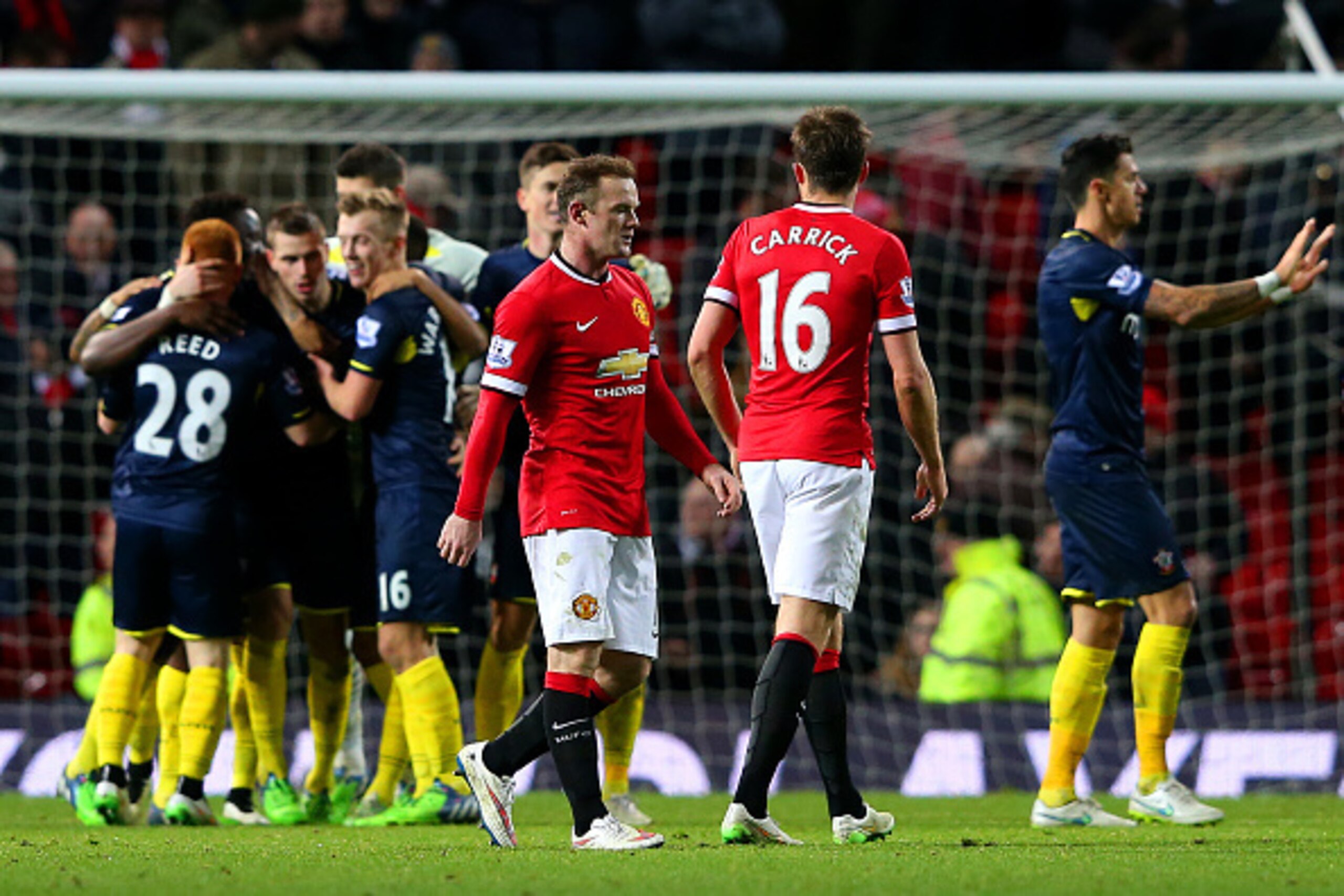 MANCHESTER, ENGLAND - JANUARY 11:  Wayne Rooney of Manchester United reacts as Southampton players celebrate victory in the Barclays Premier League match between Manchester United and Southampton at Old Trafford on January 11, 2015 in Manchester, England.