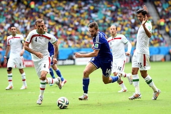 SALVADOR, BRAZIL - JUNE 25:  Tino Sven Susic of Bosnia and Herzegovina takes on Iran defence during the 2014 FIFA World Cup Brazil Group F match between Bosnia and Herzegovina and Iran at Arena Fonte Nova on June 25, 2014 in Salvador, Brazil.  (Photo by L