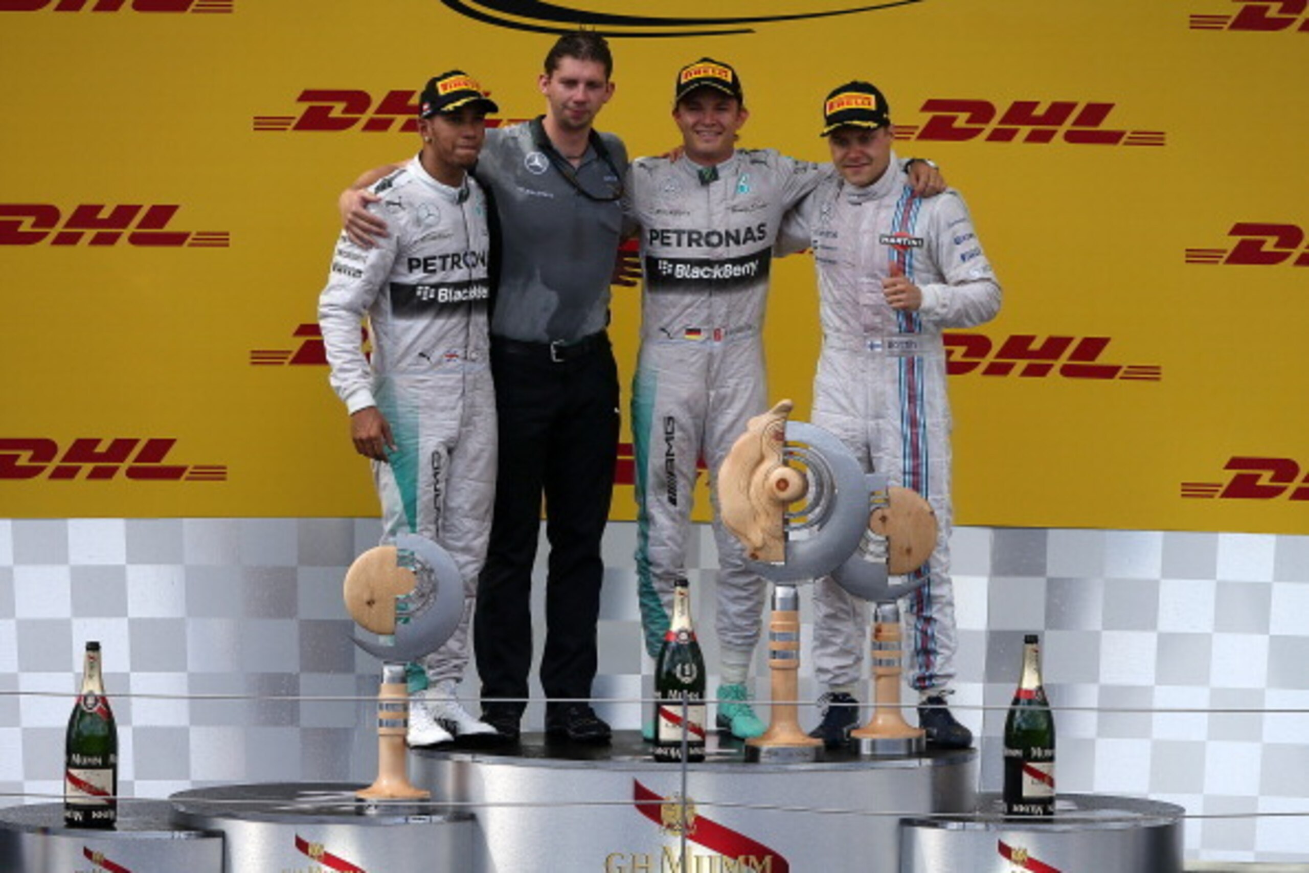 SPIELBERG, AUSTRIA - JUNE 22:  Nico Rosberg (2nd R) of Germany and Mercedes GP celebrates on the podium next to Lewis Hamilton (L) of Great Britain and Mercedes GP and Valtteri Bottas (R) of Finland and Williams after his victory in the Austrian Formula O