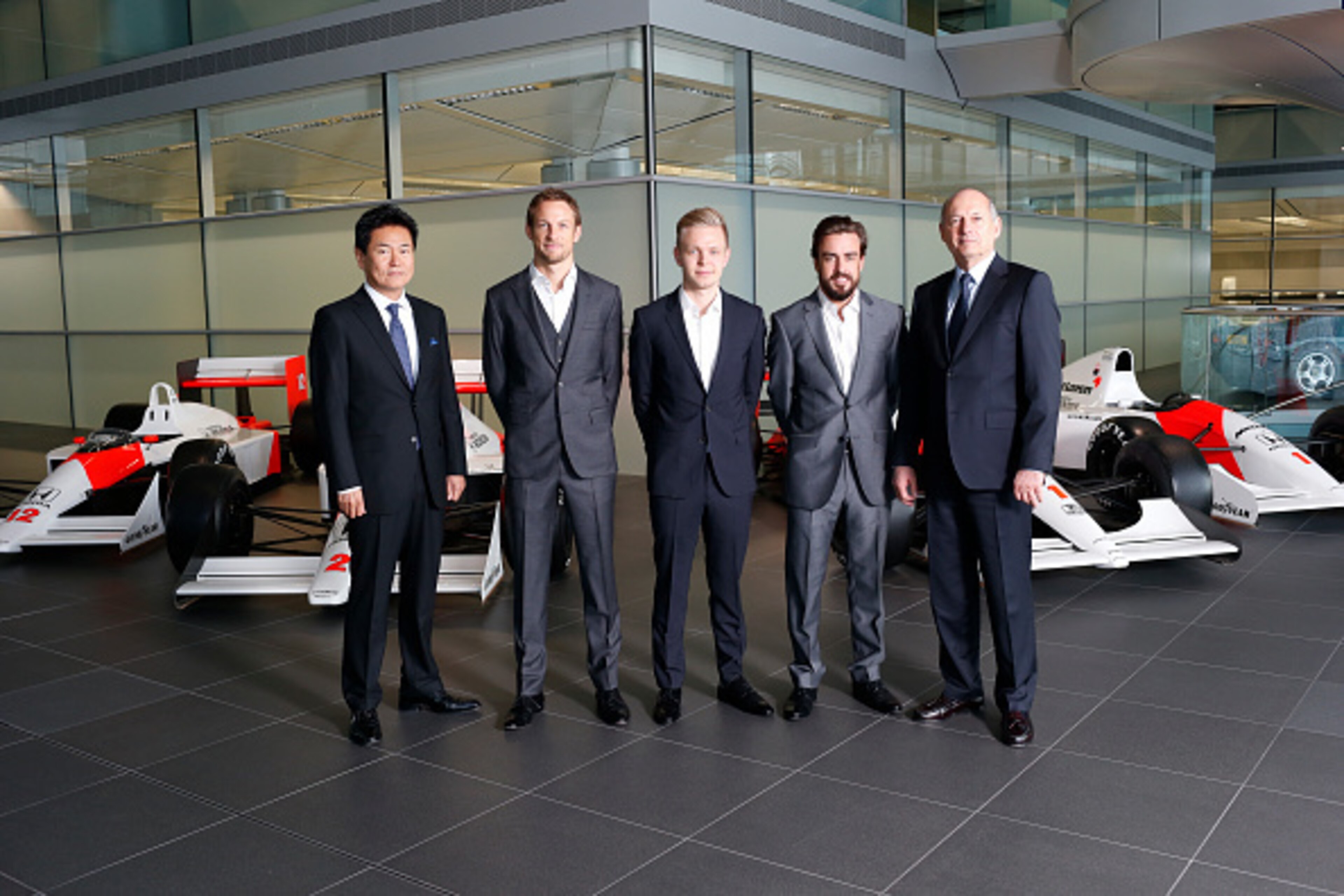 WOKING, ENGLAND- DECEMBER 10: In this handout photo provided by McLaren-Honda, Formula One drivers Fernando Alonso (2nd R) and Jenson Button (2nd L) pose as McLaren-Honda announces its new driver line-up for 2015 with Kevin Magnussen (C) who will remain a