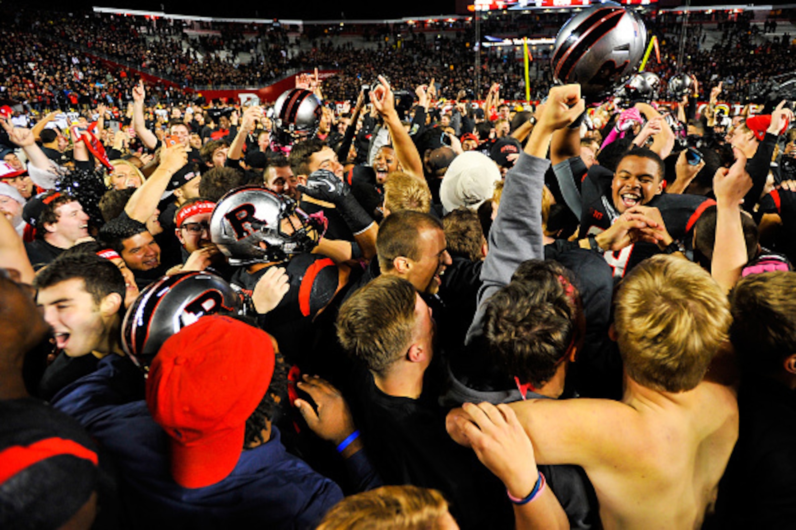 PISCATAWAY, NJ - OCTOBER 04:  Fans rush the field after the Rutgers Scarlet Knights defeated the Michigan Wolverines at High Point Solutions Stadium on October 4, 2014 in Piscataway, New Jersey.  (Photo by Alex Goodlett/Getty Images)