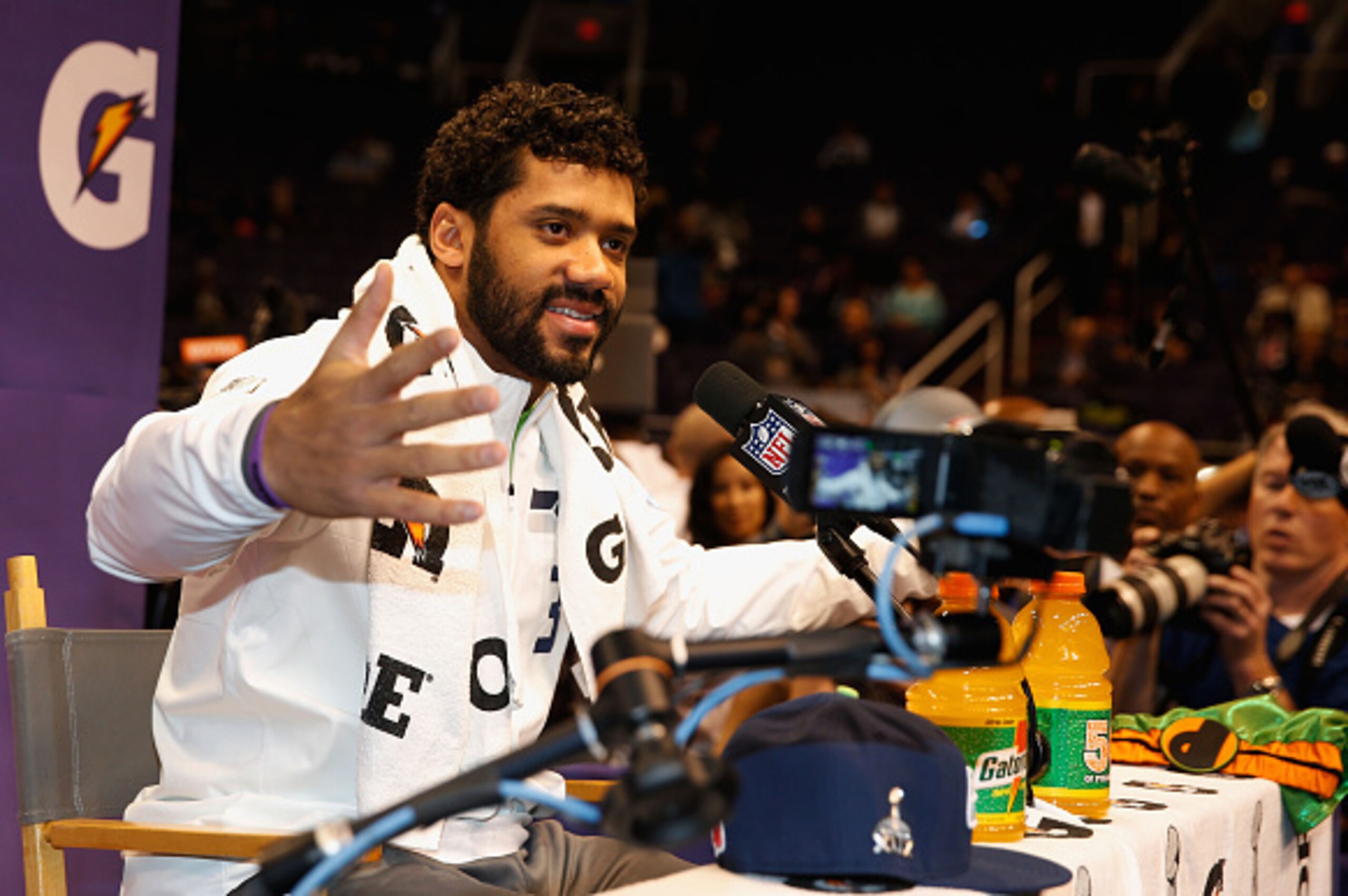 PHOENIX, AZ - JANUARY 27:  Russell Wilson #3 of the Seattle Seahawks addresses the media at Super Bowl XLIX Media Day Fueled by Gatorade inside U.S. Airways Center on January 27, 2015 in Phoenix, Arizona.  (Photo by Christian Petersen/Getty Images)