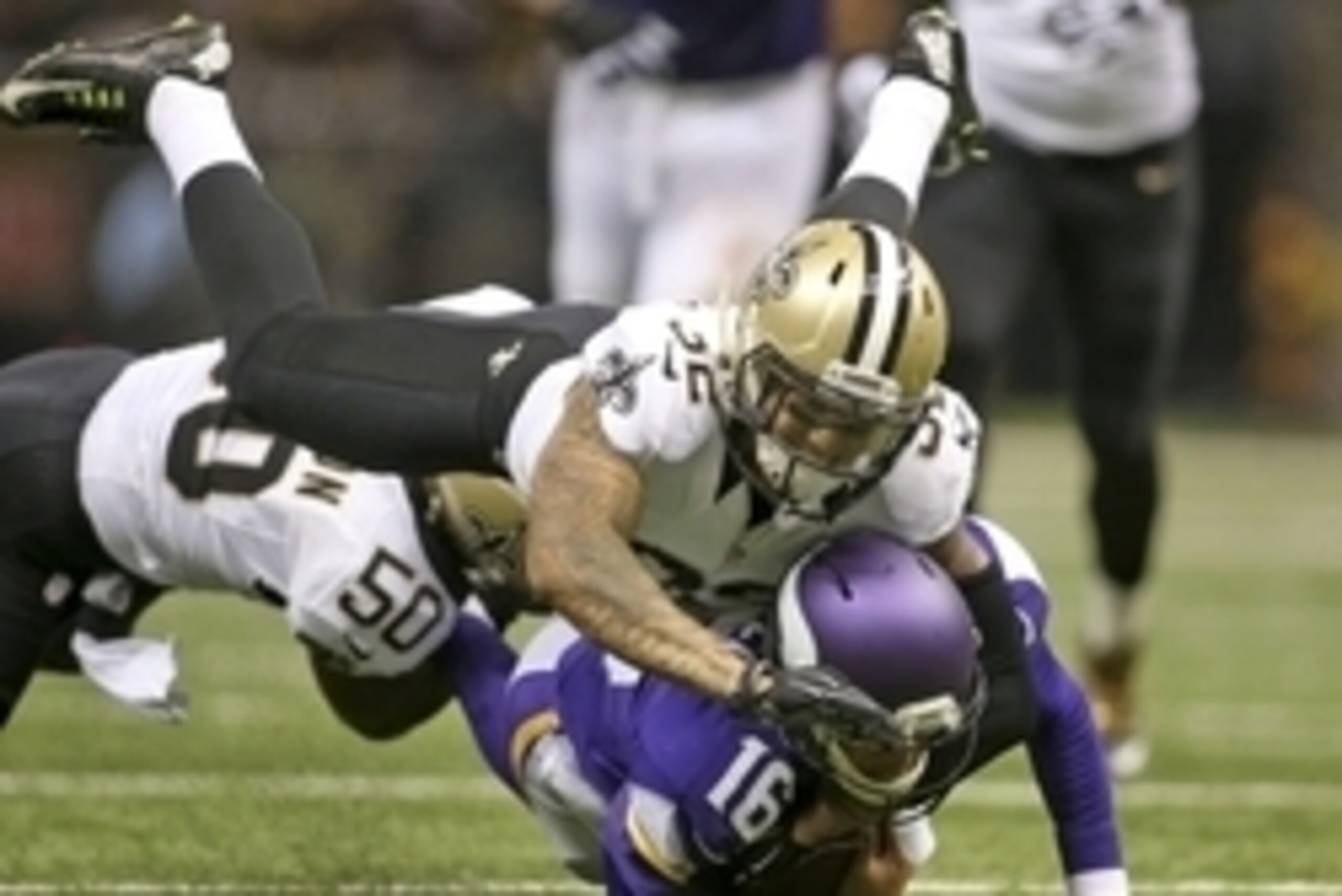 Sep 21, 2014; New Orleans, LA, USA; New Orleans Saints strong safety Kenny Vaccaro (32) and middle linebacker Curtis Lofton (50) tackle Minnesota Vikings quarterback Matt Cassel (16) in the first half at Mercedes-Benz Superdome. Mandatory Credit: Crystal 