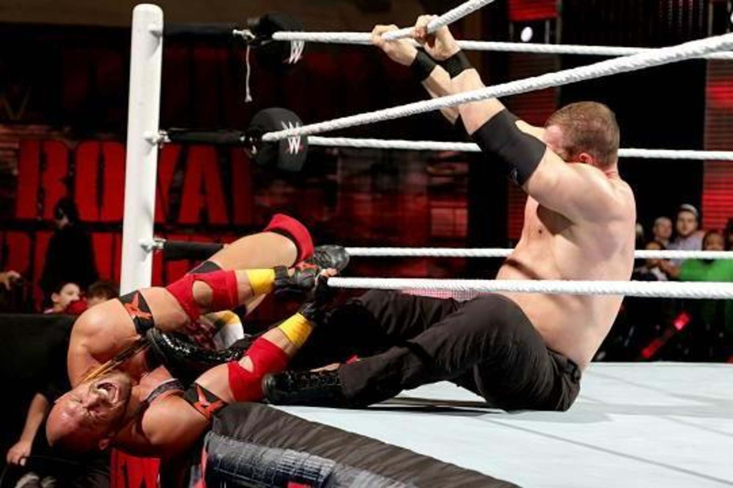 Kane pushes Ryback out of the ring at the Royal Rumble.
