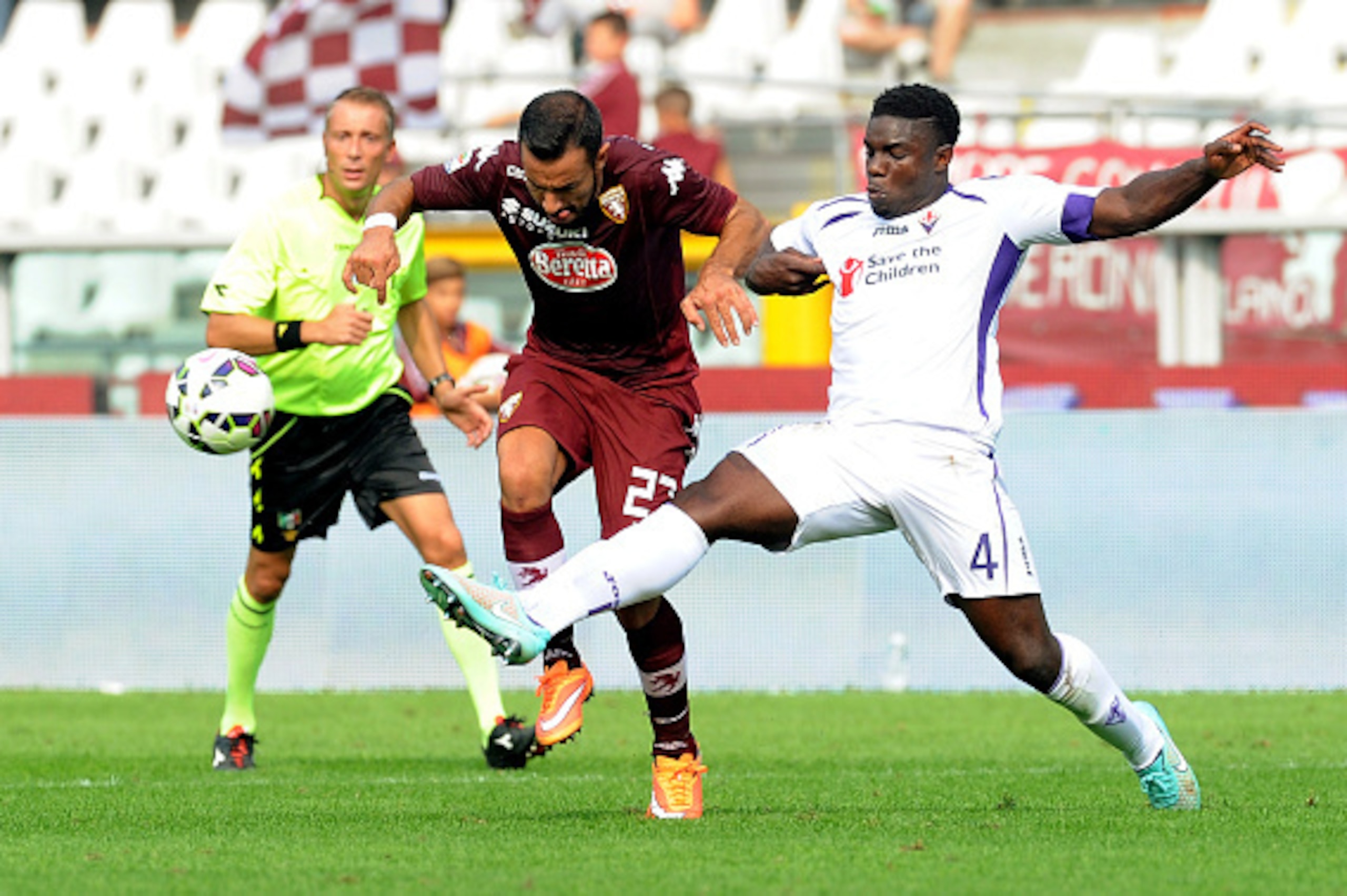 TURIN, ITALY - SEPTEMBER 28: (L-R) Fabio Quagliarella of Torino FC competes for the ball against Micah Richards of AFC Fiorentina during the Serie A match between Torino FC and ACF Fiorentina at Stadio Olimpico di Torino on September 28, 2014 in Turin, It