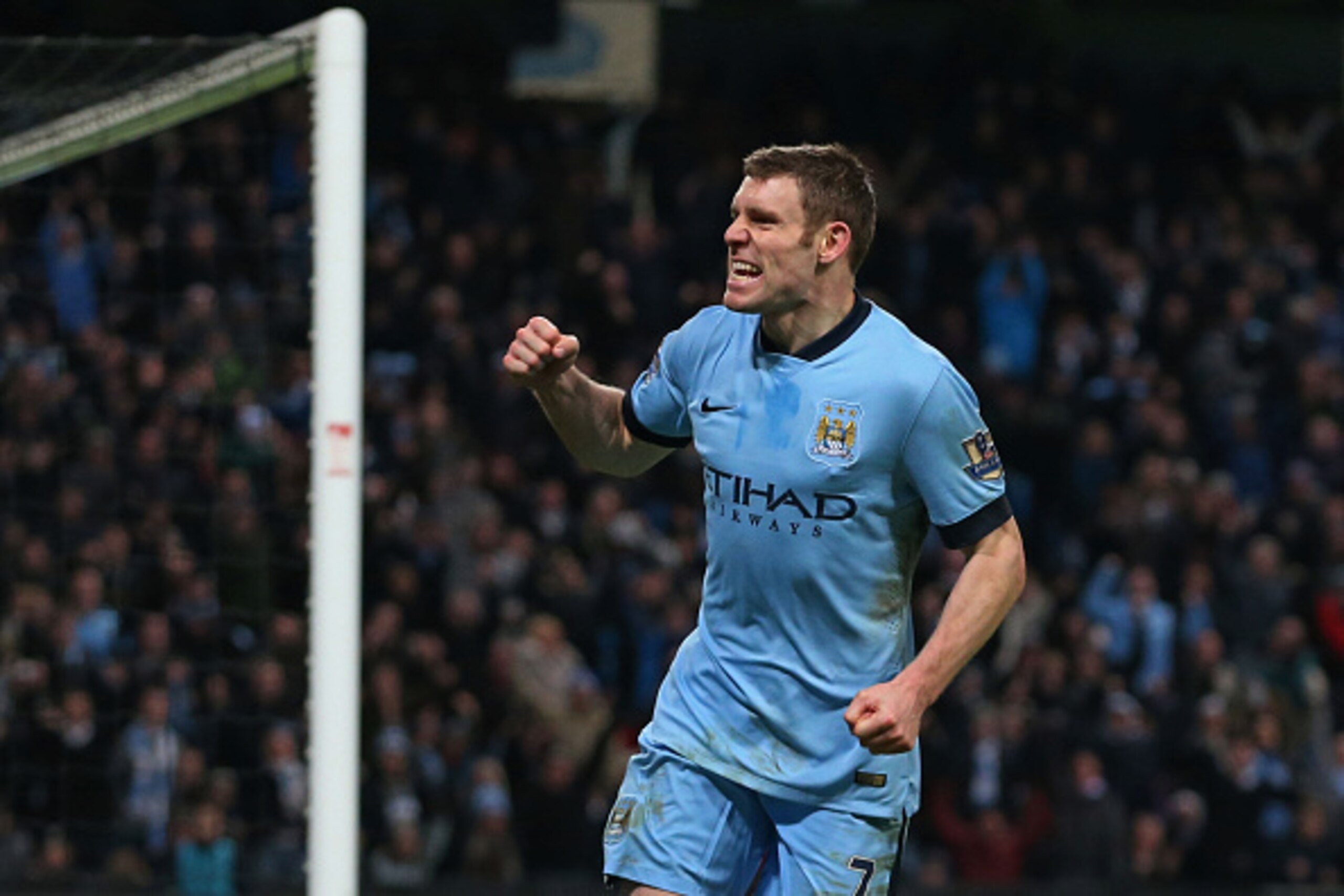 MANCHESTER, ENGLAND - JANUARY 04:  James Milner of Manchester City celebrates after scoring a goal to level the scores at 1-1 during the FA Cup Third Round match between  Manchester City and Sheffield Wednesday at Etihad Stadium on January 4, 2015 in Manc