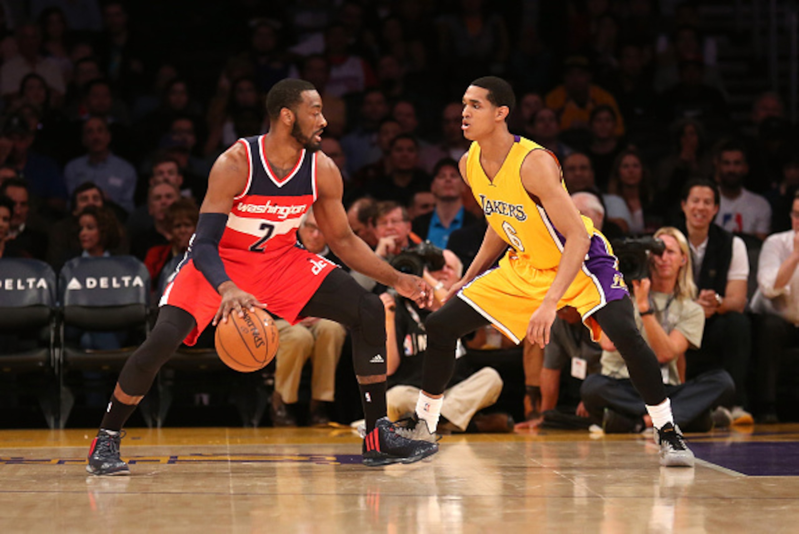 LOS ANGELES, CA - JANUARY 27:  John Wall #2 of the Washington Wizards drives against Jordan Clarkson #6 of the Los Angeles Lakers at Staples Center on January 27, 2015 in Los Angeles, California.   NOTE TO USER: User expressly acknowledges and agrees that