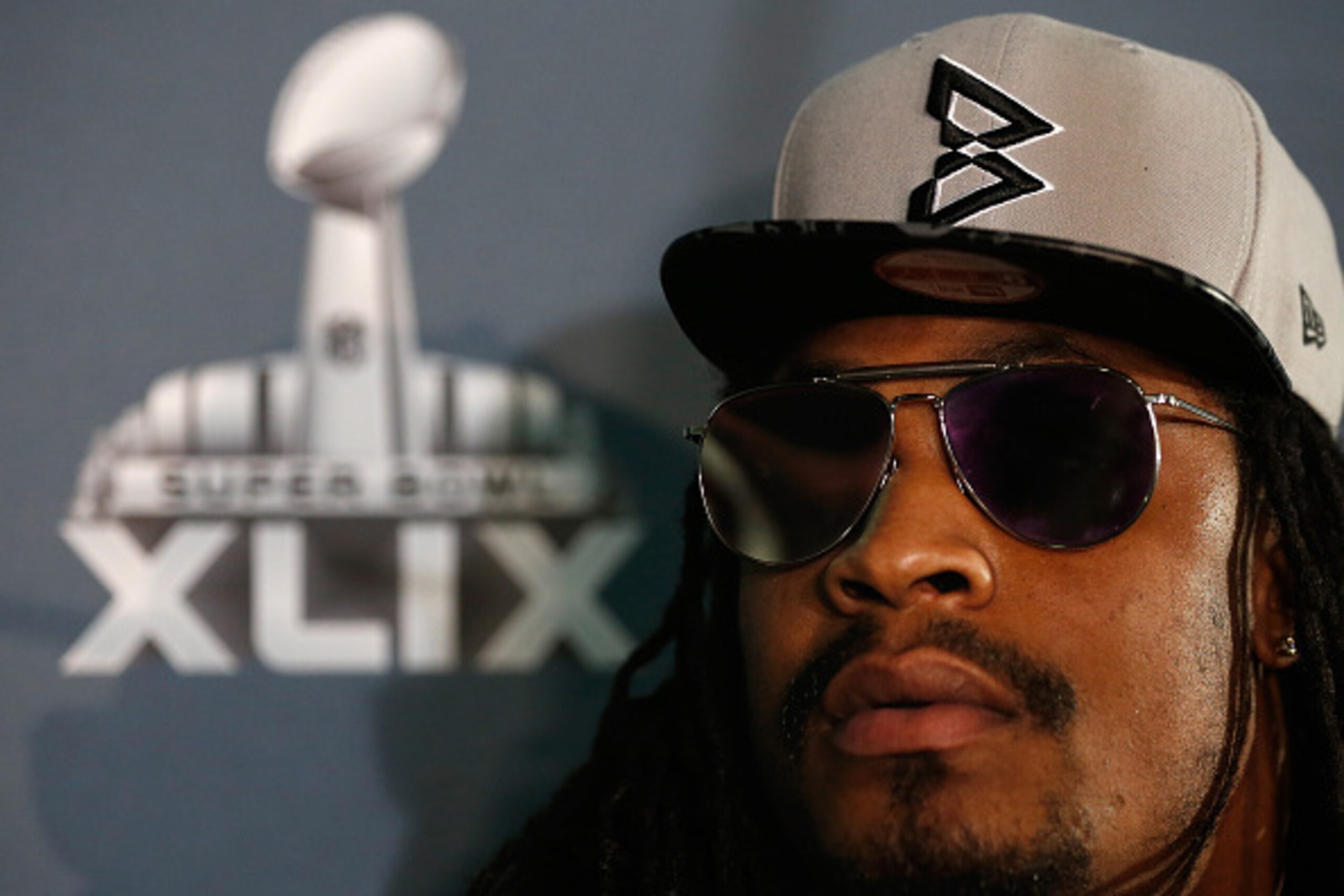 CHANDLER, AZ - JANUARY 28:  Running back Marshawn Lynch #24 of the Seattle Seahawks sits at his podium during a Super Bowl XLIX media availability at the Arizona Grand Hotel on January 28, 2015 in Chandler, Arizona.  (Photo by Christian Petersen/Getty Ima