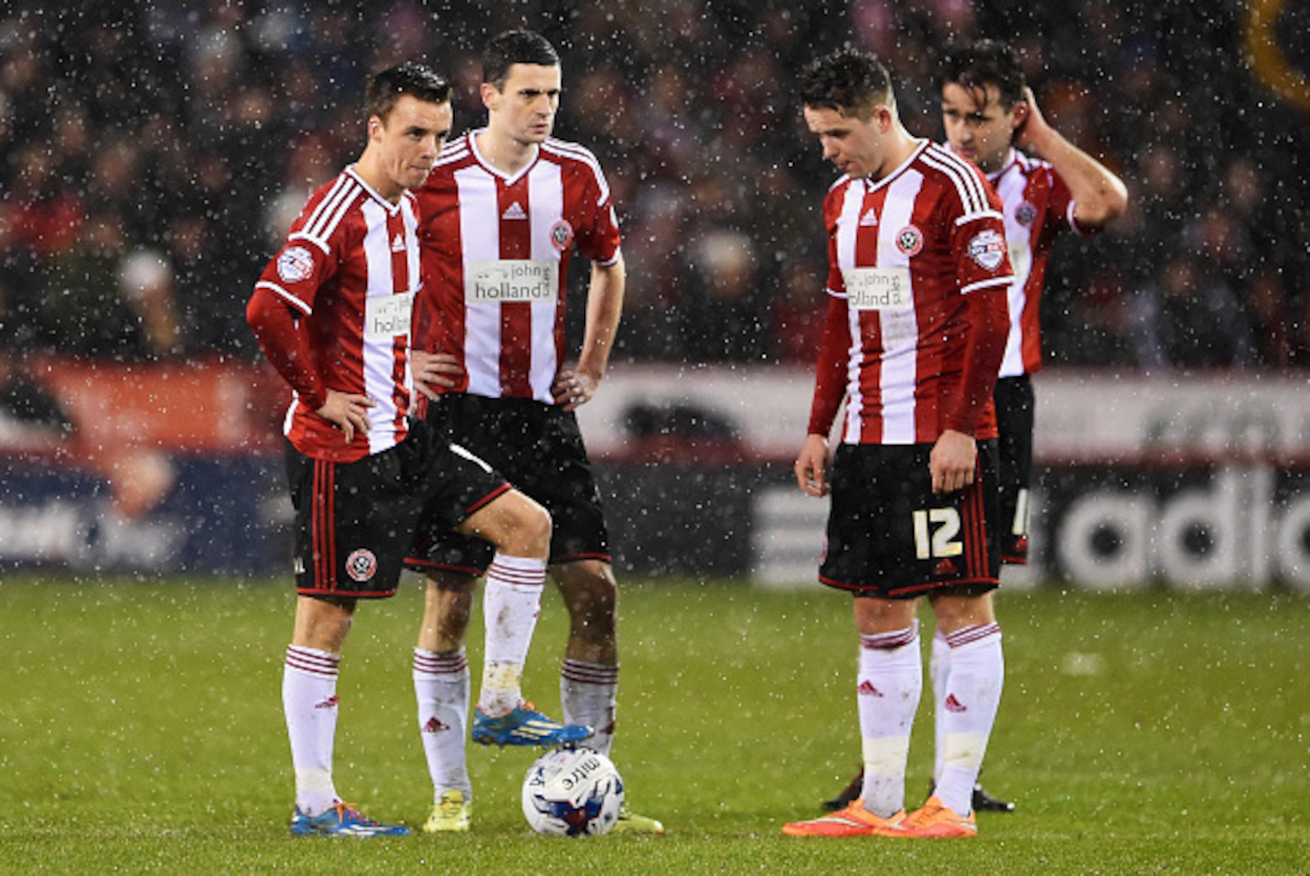 SHEFFIELD, ENGLAND - JANUARY 28: Sheffield United players look dejected after the opening goal scored by Christian Eriksen of Tottenham Hotspur during the Capital One Cup Semi-Final Second Leg match between Sheffield United and Tottenham Hotspur at Bramal