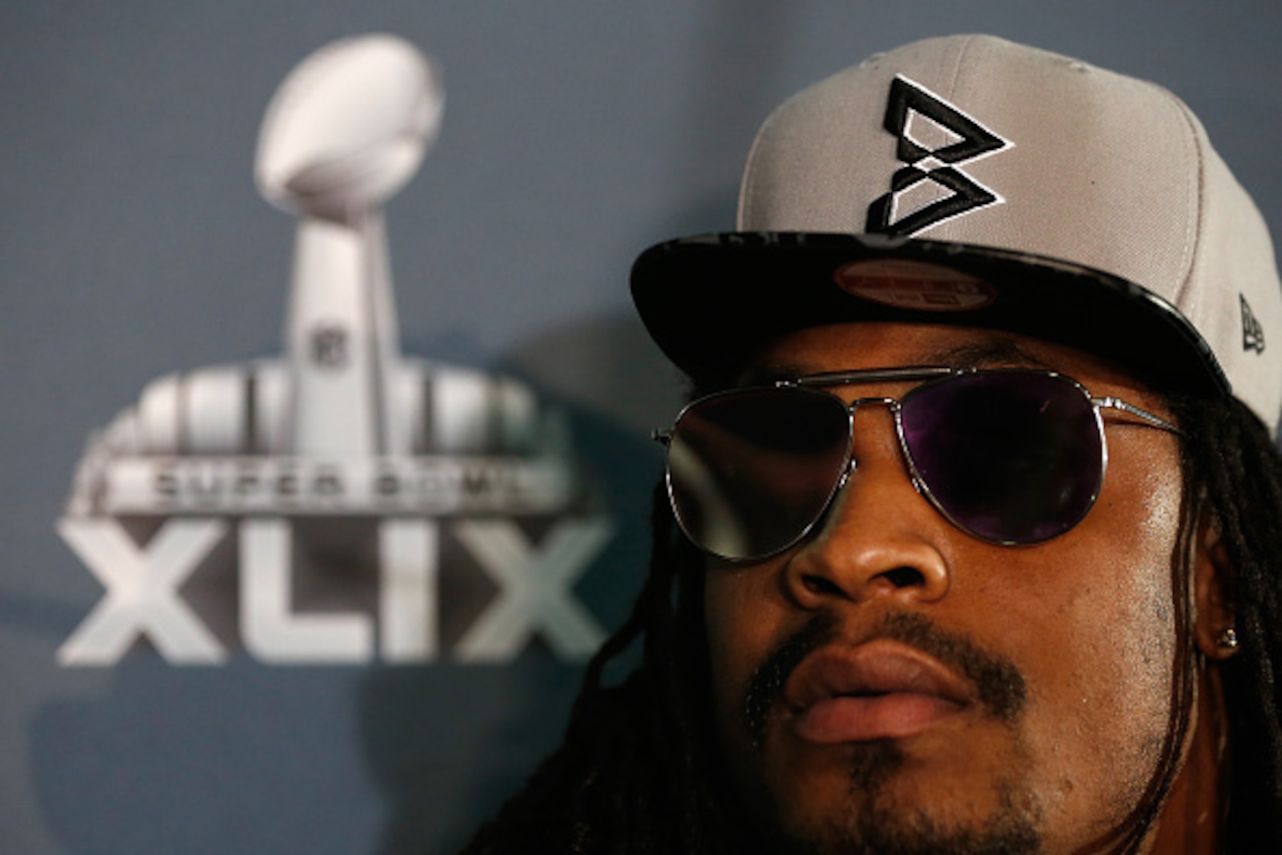CHANDLER, AZ - JANUARY 28:  Running back Marshawn Lynch #24 of the Seattle Seahawks sits at his podium during a Super Bowl XLIX media availability at the Arizona Grand Hotel on January 28, 2015 in Chandler, Arizona.  (Photo by Christian Petersen/Getty Ima
